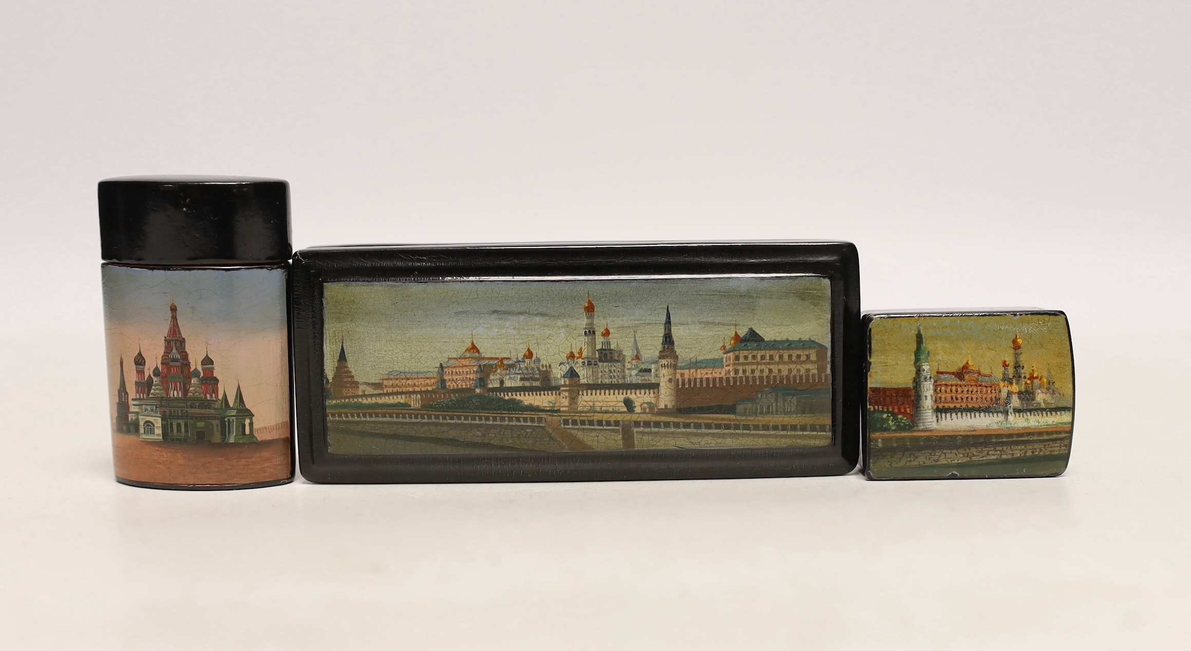 Two Russian lacquer ‘Kremlin’ stamp boxes and a similar vesta case, c.1900, largest 11cm, Please note this lot attracts an additional import tax of 5% on the hammer price                                                  