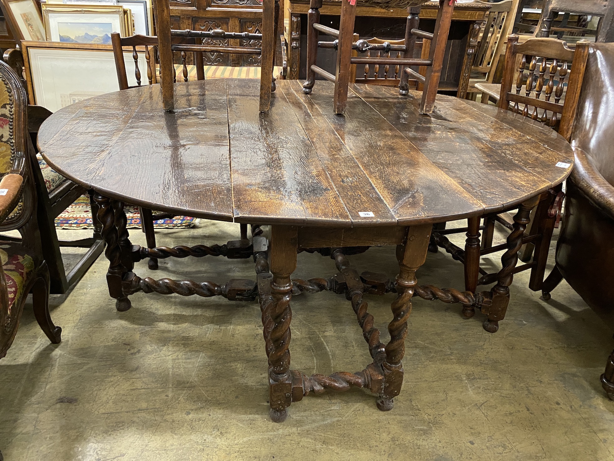 An 18th century oak gateleg dining table, length 172cm, extended, width 152cm, height 73cm                                                                                                                                  