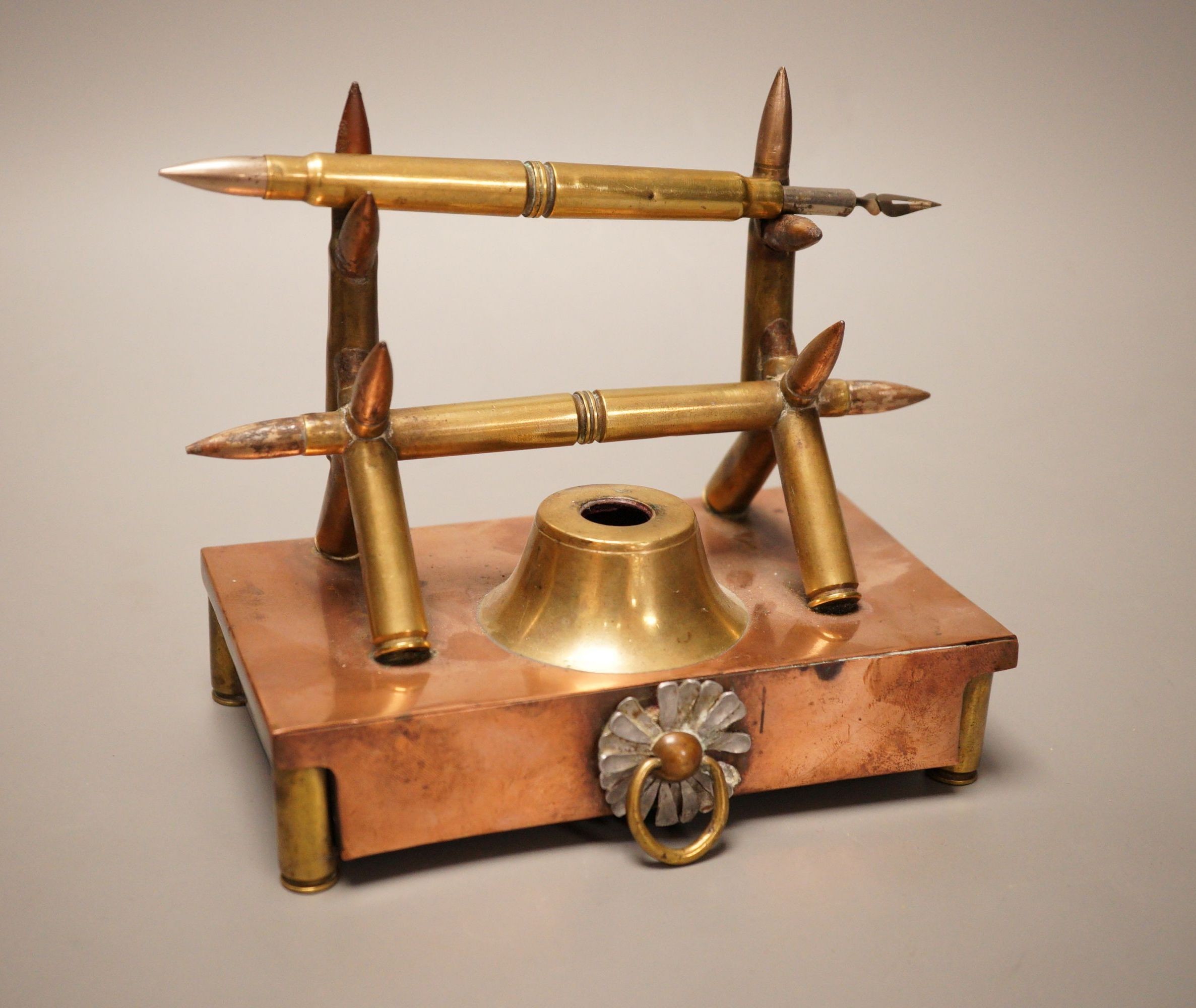 A copper and brass Trench art desk stand, 16cm wide                                                                                                                                                                         