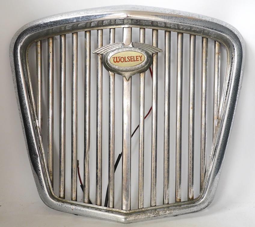 A 1950s Wolseley automobile radiator grill, with a lit logo to the centre of the grill, 40cm x 43cm. Condition - fair to good                                                                                               