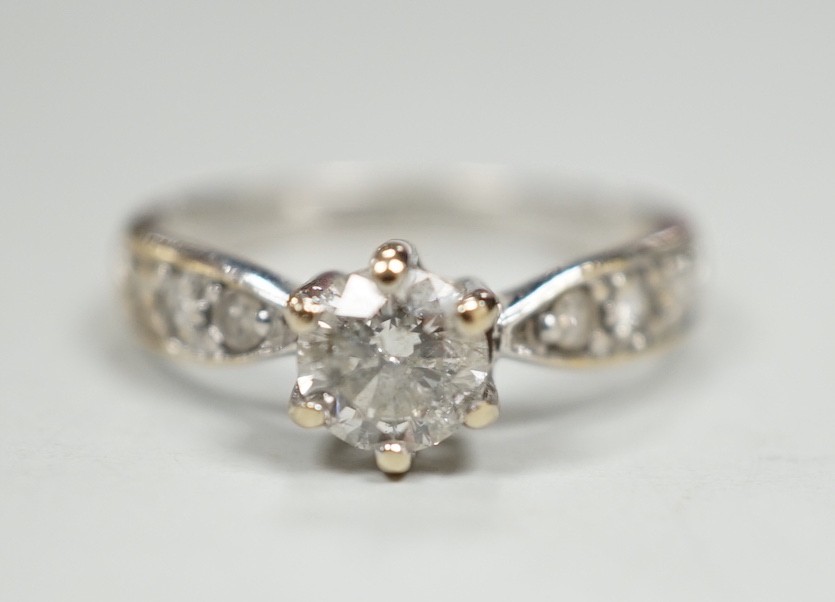 A modern 18ct gold and single stone diamond ring, with diamond set shoulders, size J, gross weight 2.4 grams                                                                                                                