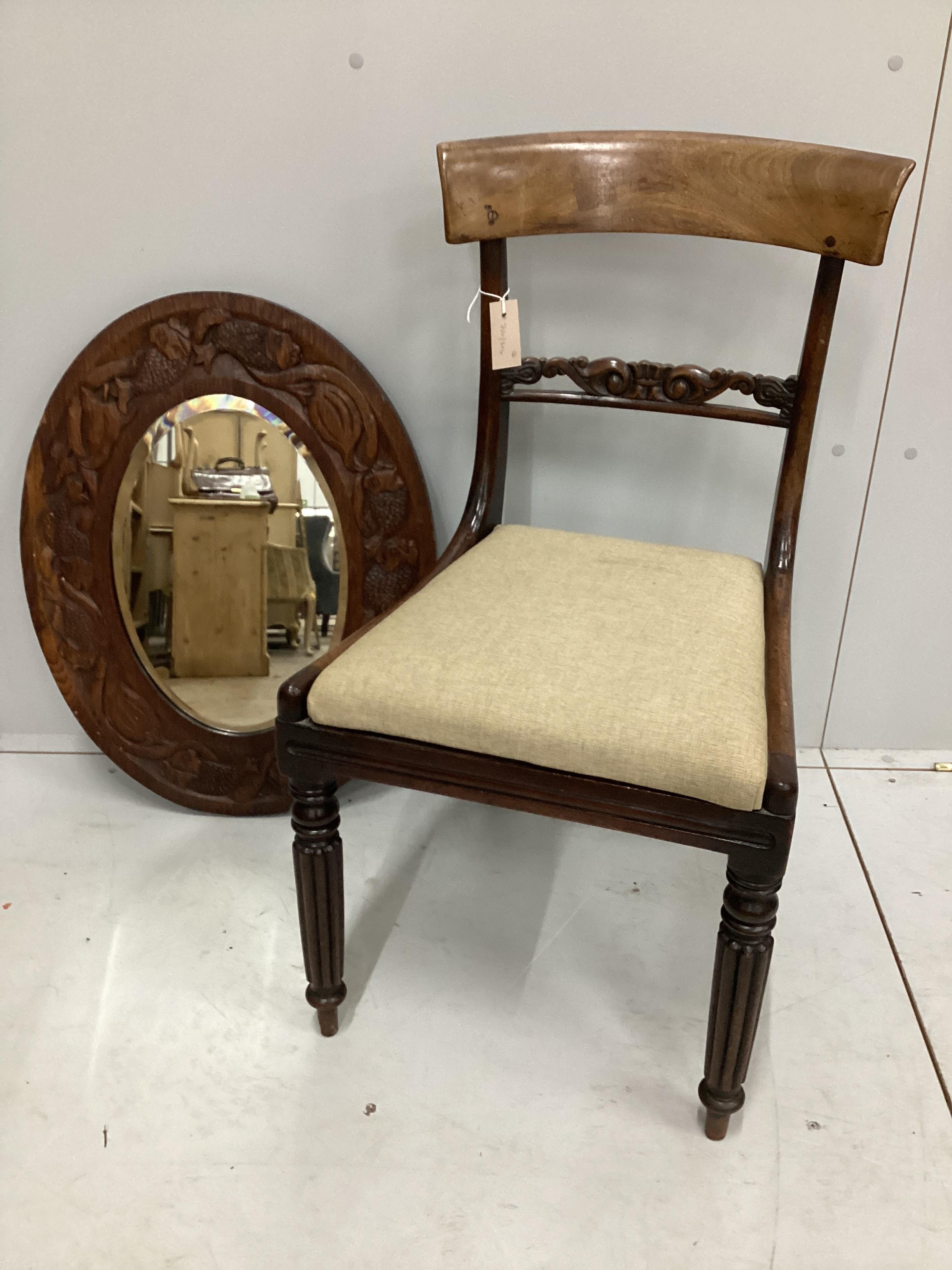 A William IV mahogany dining chair and a carved oak oval wall mirror, mirror width 67cm, height 53cm                                                                                                                        
