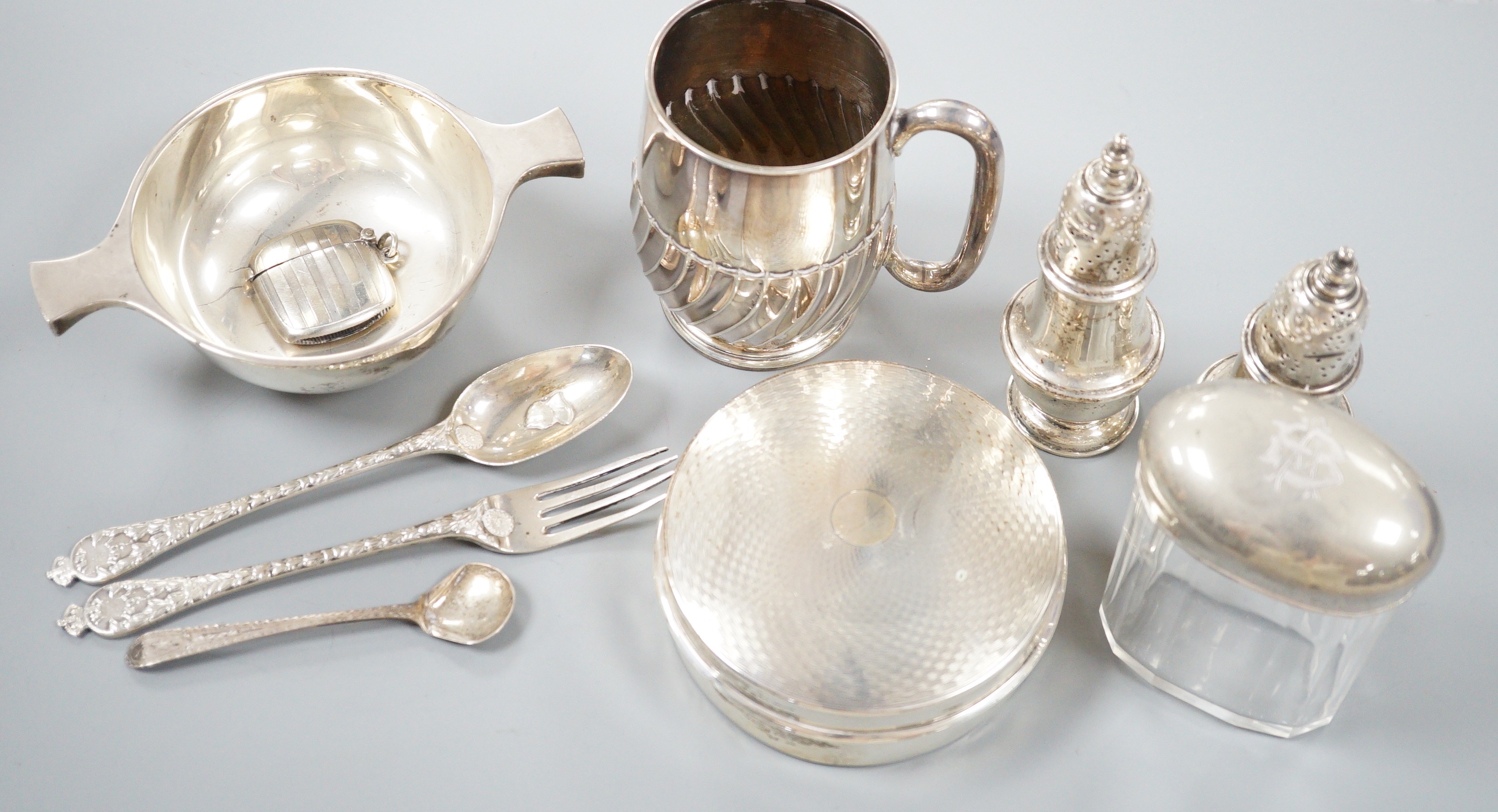Small silver including a George V quaich, Edinburgh, 1928, a pair of condiments, circular box and cover, mug, toilet jar and three items of cutlery.                                                                        