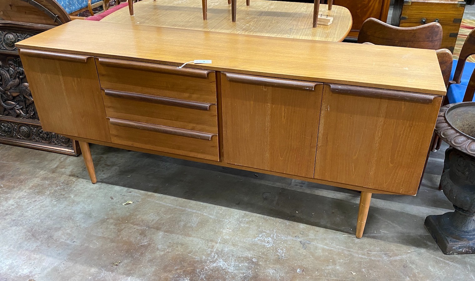 A mid century design teak sideboard, length 182cm, depth 47cm, height 79cm and extending dining table                                                                                                                       