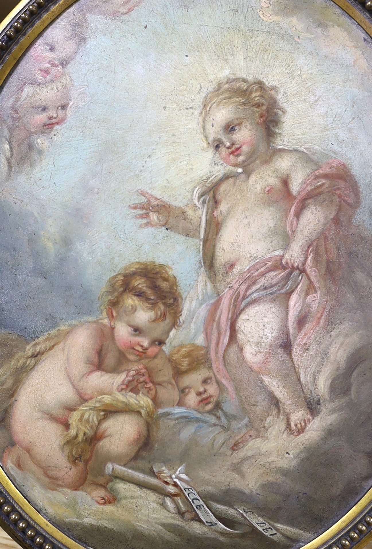 After Francois Boucher (French, 1703-1770) Celestial scene - The infant Jesus blessing St. John the Baptist, with a banner- ‘’Ecce Angus Dei’’ [Behold the Lamb of God] oil on canvas laid down21 x 17cm, framed to the oval