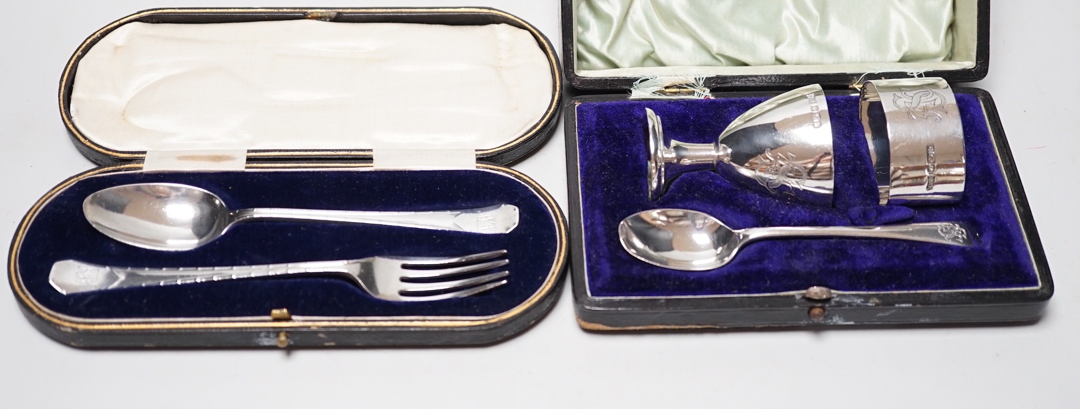 A cased George V silver christening trio, by Walker & Hall, Sheffield, 1925 and a cased silver christening spoon & fork, Henry Wigful, Sheffield, 1925.                                                                     