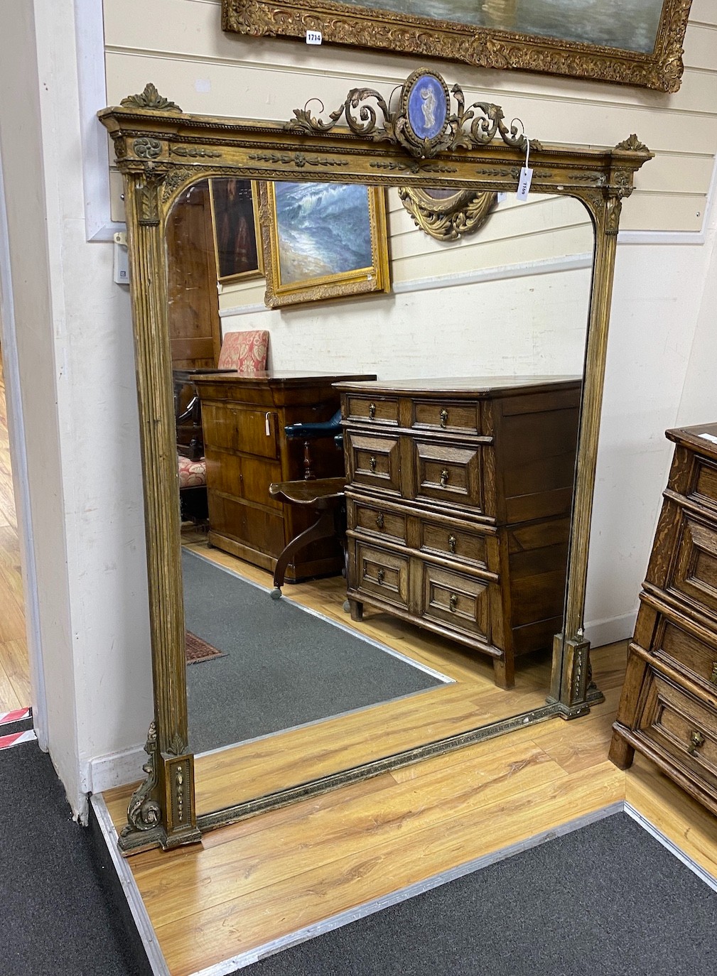 A Victorian giltwood and gesso overmantel mirror with simulated blue jasper pediment width 133cms, height 167cms.                                                                                                           
