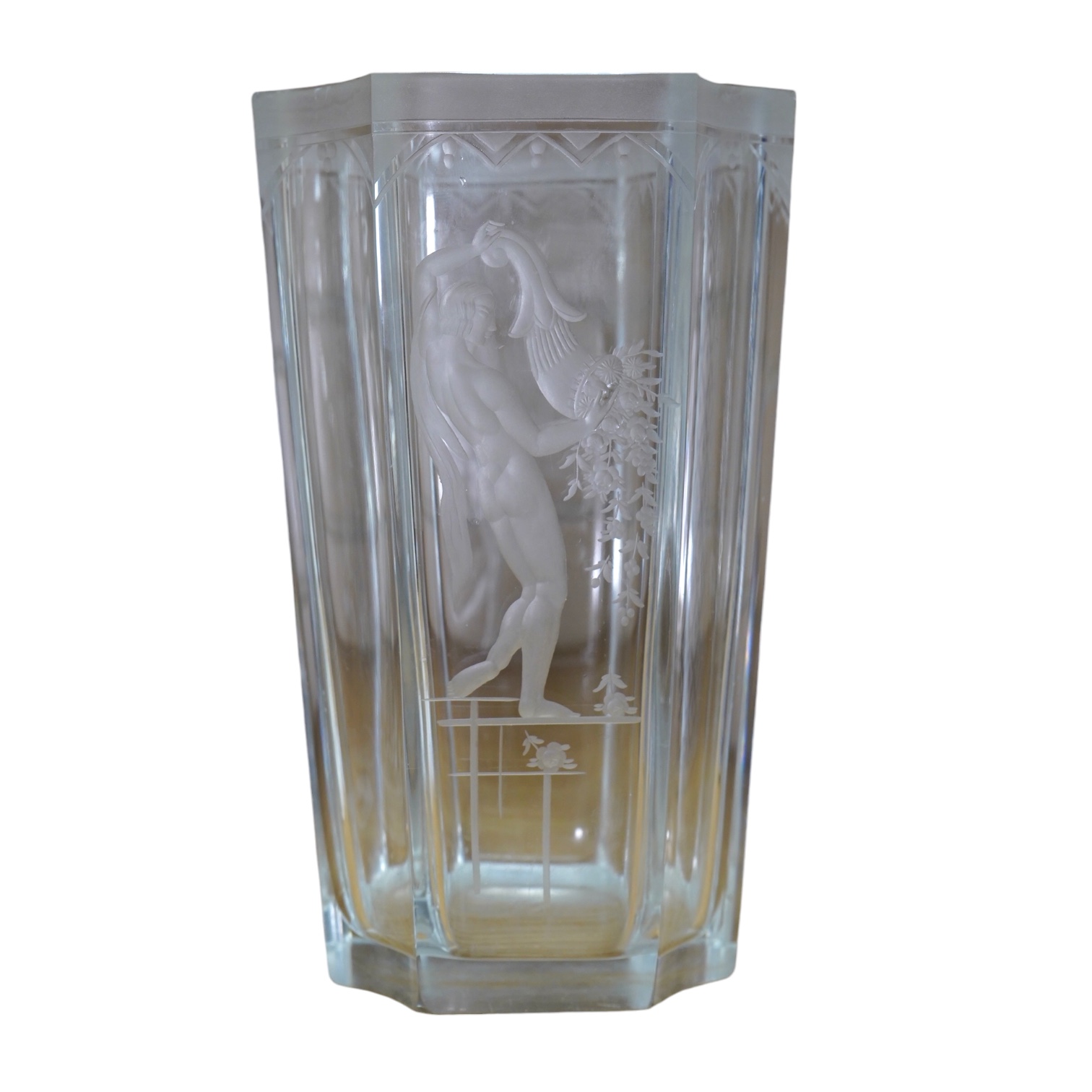 Emil Weidlich for Elme, a 1930s Swedish cut and etched glass vase decorated with a figure tipping a floral cornucopia. Condition - minute chips to two corner tips of the rim otherwise very good, The glass engraver Weidli