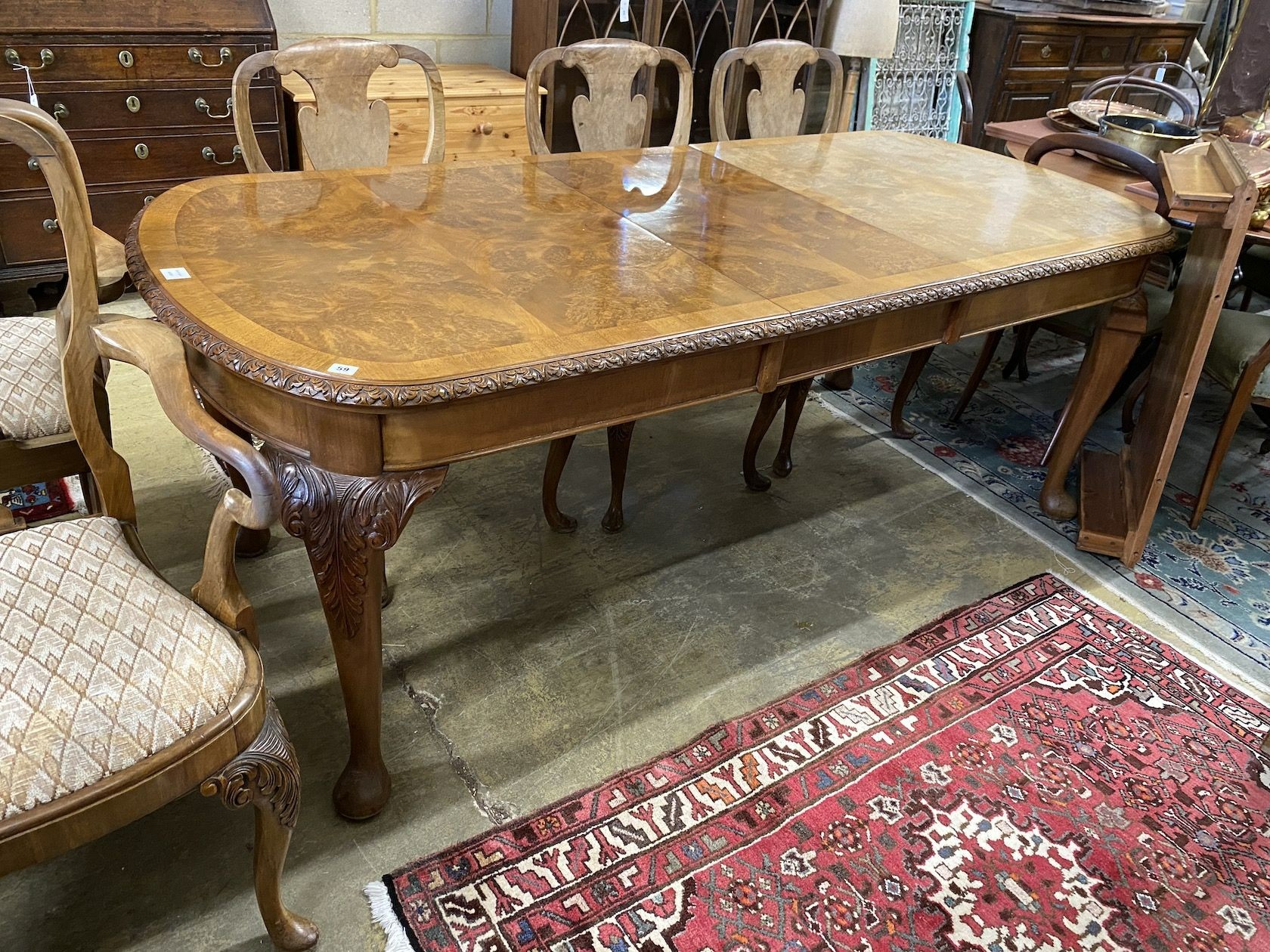 A Queen Anne revival burr walnut extending dining table, approx. 250cm extended, two spare leaves, width 90cm, height 77cm                                                                                                  