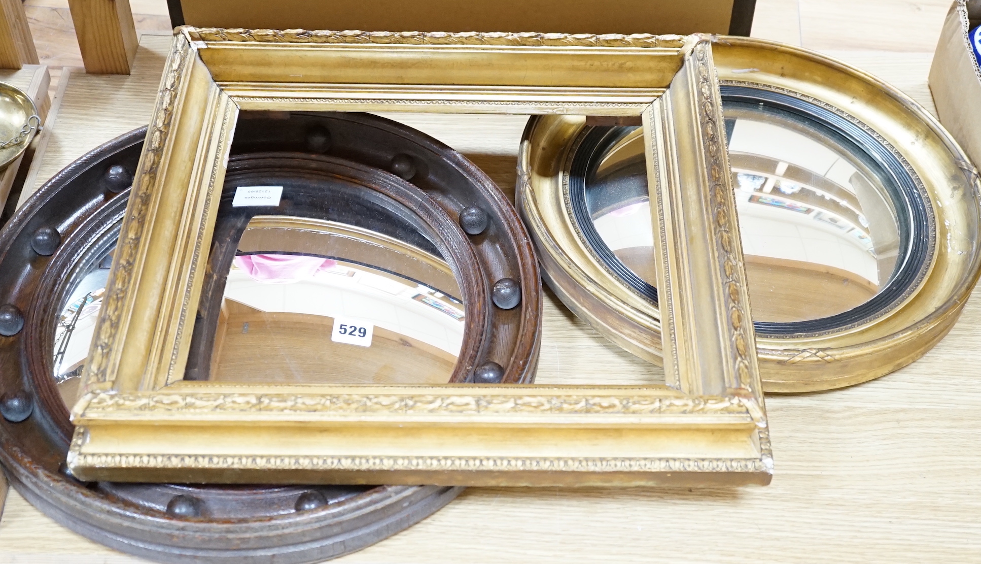 Two Victorian convex wall mirrors and a gilt painted picture frame, largest mirror 46cm diameter                                                                                                                            