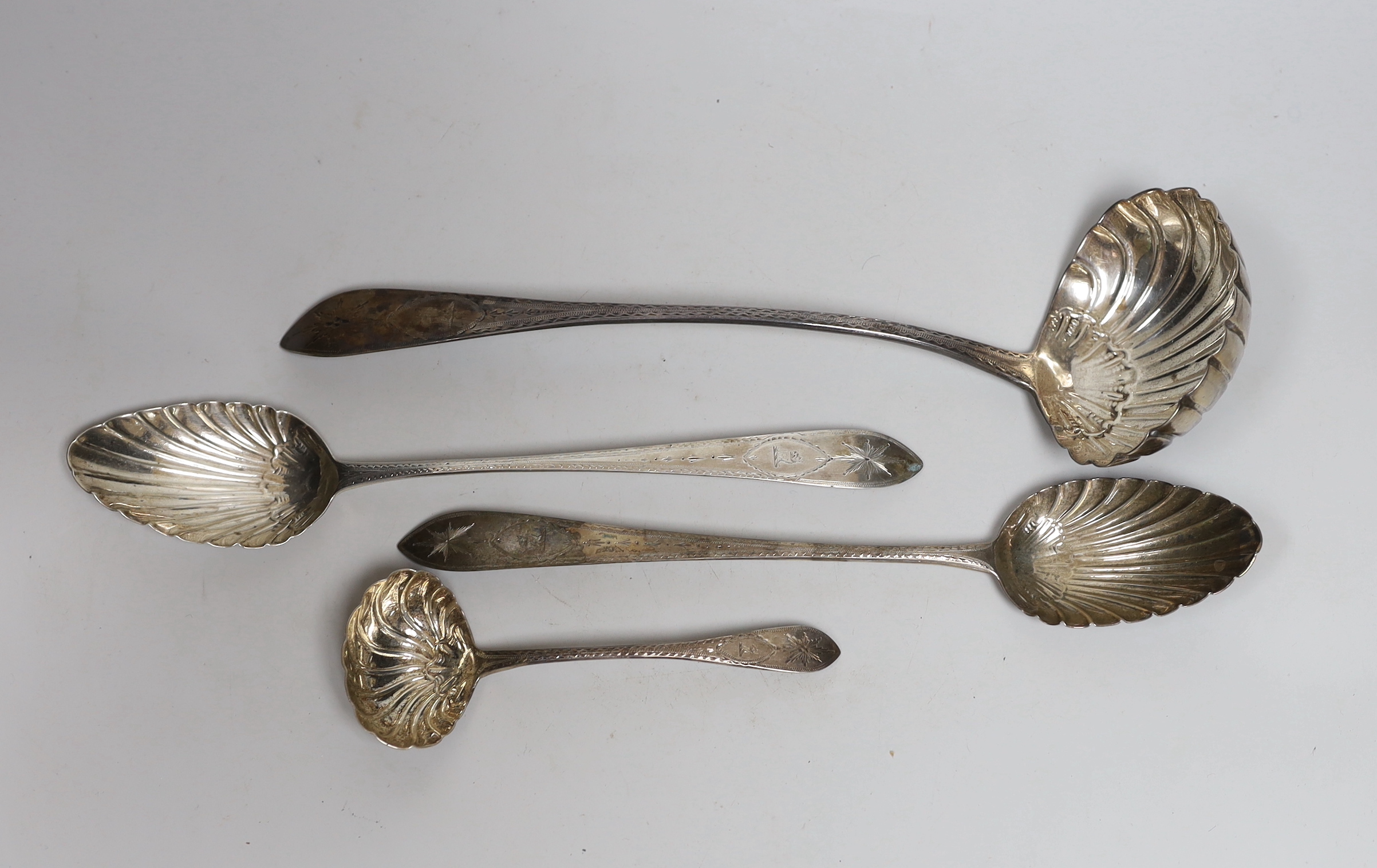A George IV silver bright cut engraved soup ladle, with fluted bowl, Lawrence Nolan, Dublin, 1827, 34.5cm, a pair of George III Irish silver basting spoons, Michael Keating, Dublin circa 179o and an Irish silver sauce la