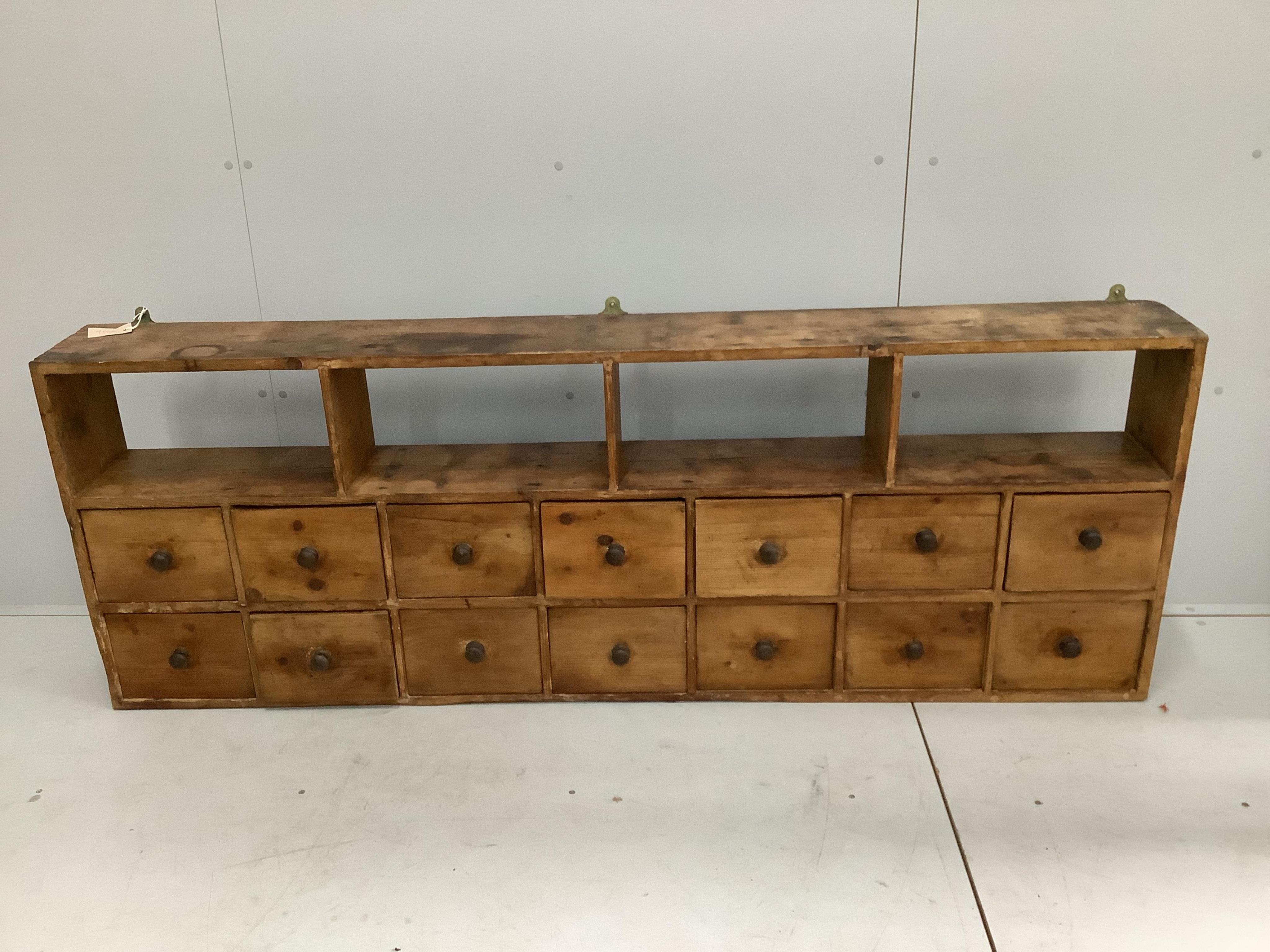 A Victorian pine bank of fourteen drawers, width 183cm, depth 21cm, height 66cm                                                                                                                                             