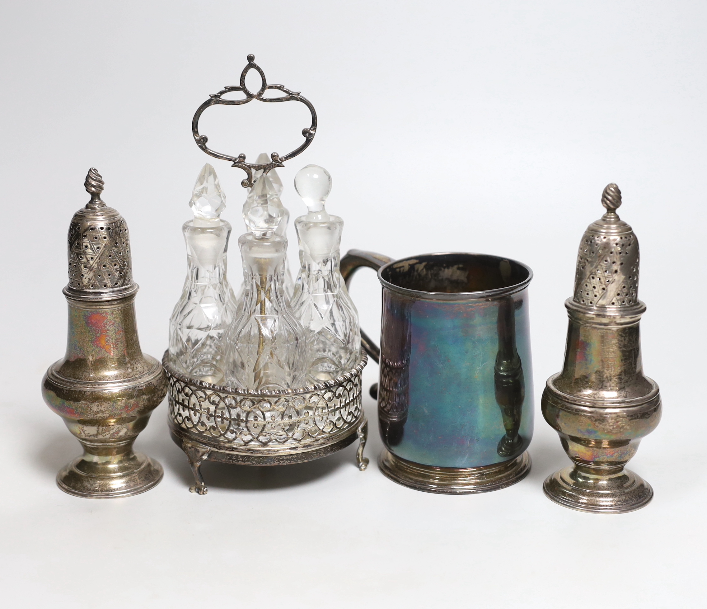 An early George II silver mug, Thomas Mason, London, 1728, 9cm, two George III silver pepperettes, I.D. London, 1763 and Thomas & Jabez Daniell, London, 1773 and a 19th century unmarked white metal cruet stand with four 