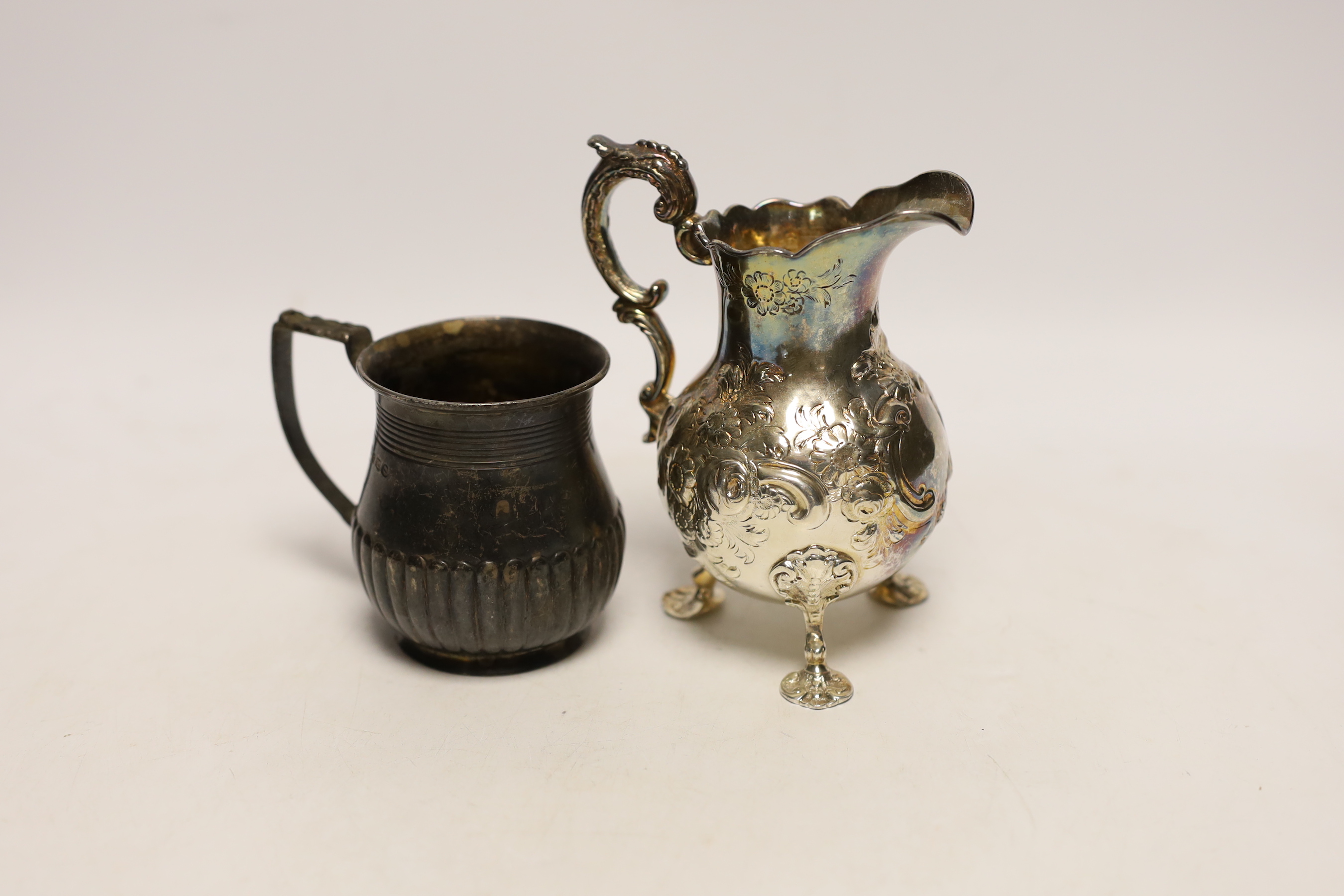 A George III demi fluted silver christening mug, by Emes & Barnard, London, 1814, 76mm, together with a later embossed silver cream jug, London, 1851, 9.8oz.                                                               