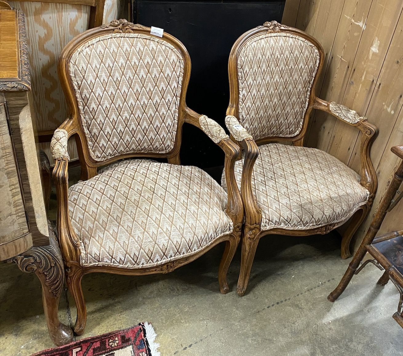 A pair of Louis XV style beech fauteuil, with a tapestry upholstered seat and back, width 55cm, depth 48cm, height 90cm                                                                                                     