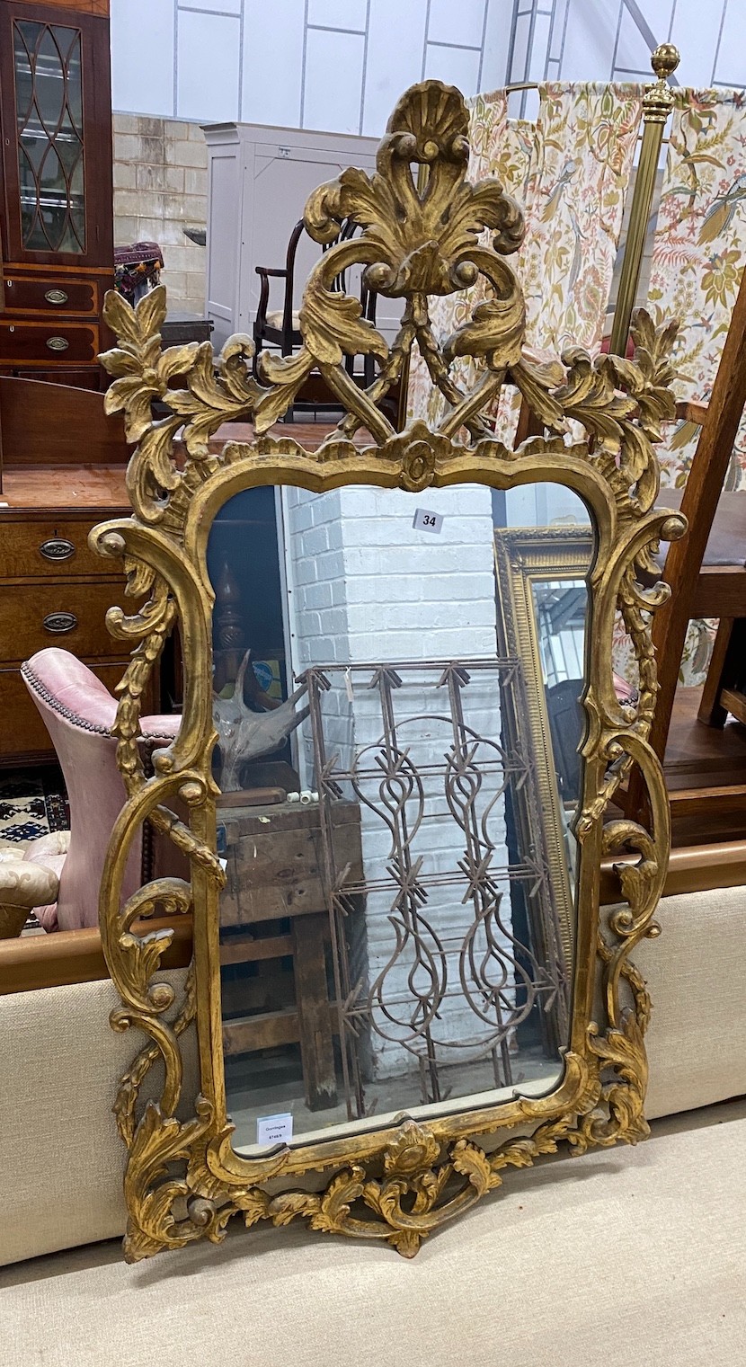 An 18th century style carved giltwood scrollwork mirror, width 64cm, height 132cm                                                                                                                                           