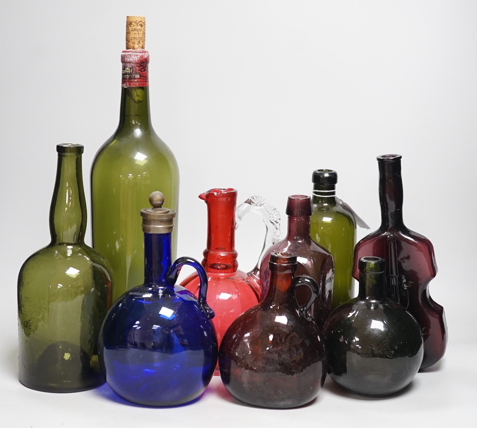 A collection 19th/20th century coloured glass bottles and jugs                                                                                                                                                              