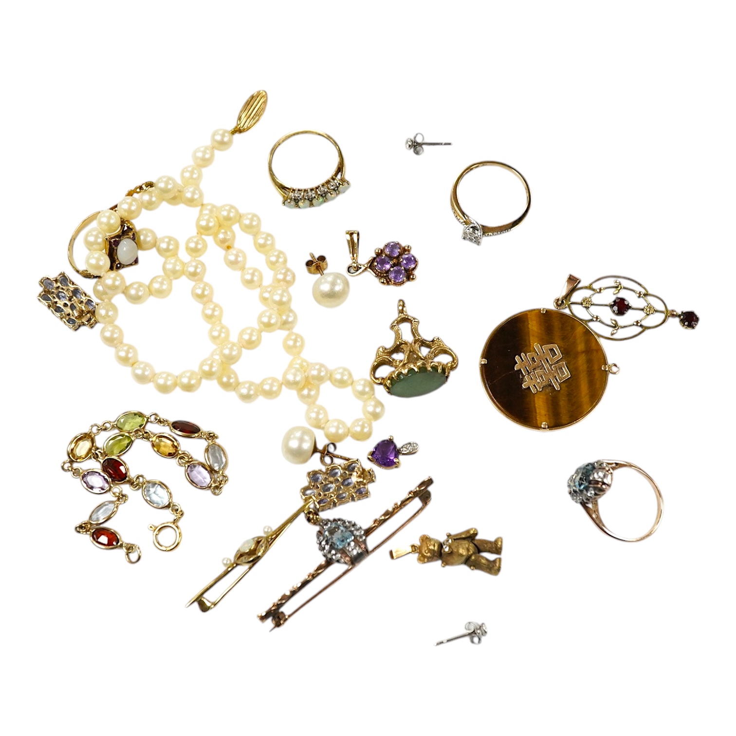 A group of assorted mainly modern 9ct and gem set jewellery including pendants, rings, bracelet, fob seal, ear studs, bar brooches, etc. and a single strand cultured pearl necklace. Condition - poor to fair to good.     