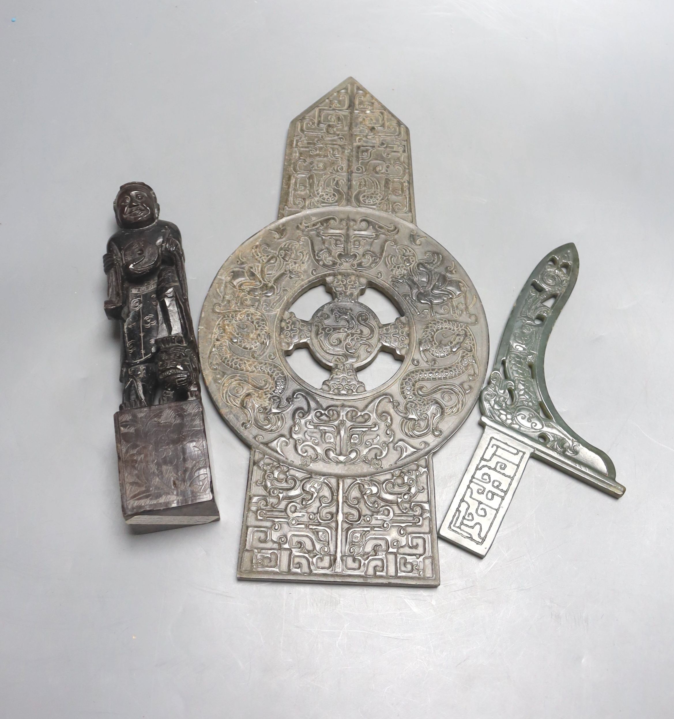 A Chinese archaistic stone plaque, a green hardstone model of an axe dagger and a soapstone 'Liu Hai' seal (3)                                                                                                              