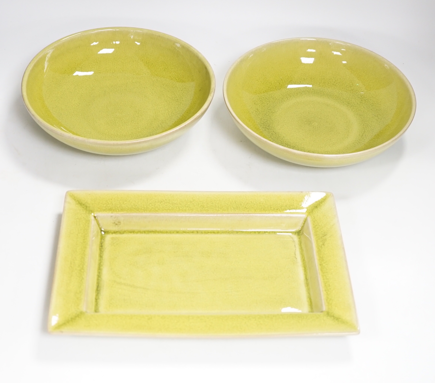 Two lime green crackle glazed bowls and a similar rectangular dish, by Jars of France, largest 30cm                                                                                                                         