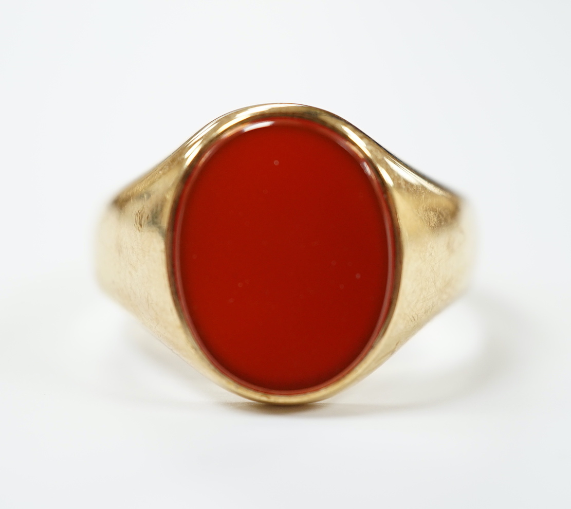 A 9ct gold and single stone oval carnelian set signet ring, size W, gross weight 8.7 grams.                                                                                                                                 