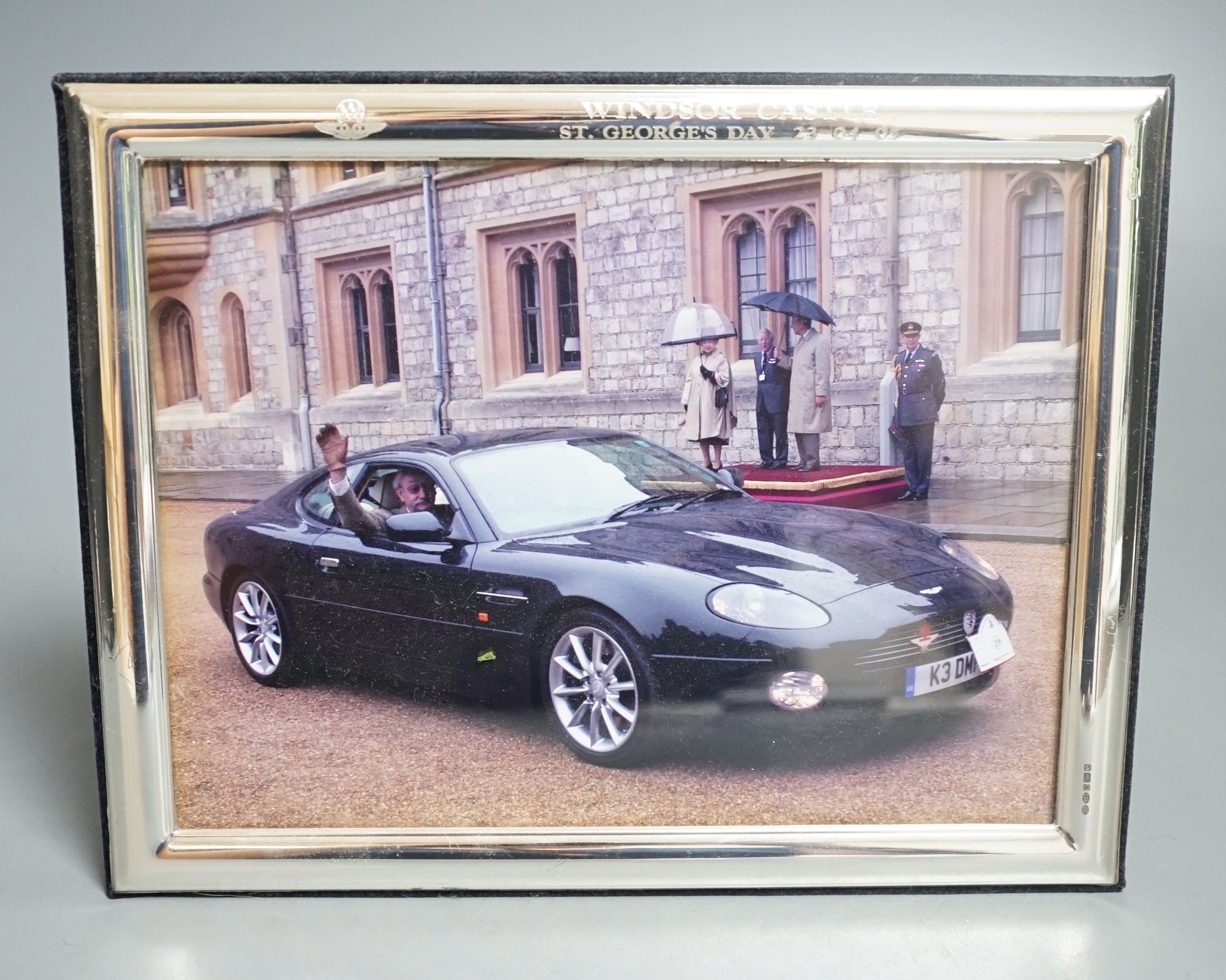 A modern Italian 925 mounted photograph frame, engraved with the Aston Martin Owners Club emblem and inscribed 'Windsor Castle St. Georges Day 23/04/05', 23.1cm by 18.2cm.                                                 