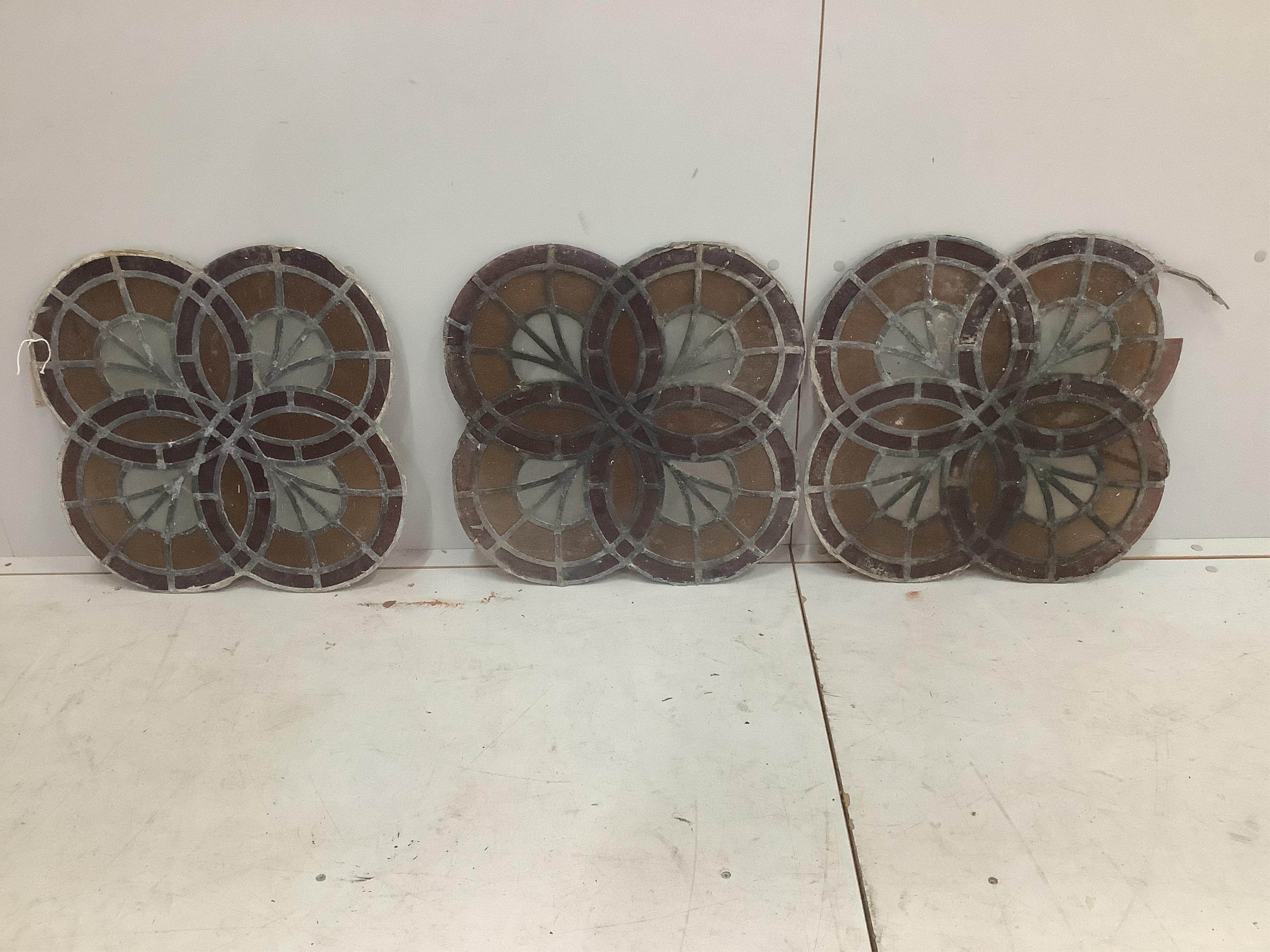 A set of three stained glass panels, 50 x 50cm. Condition - one section of glass missing and some leading missing                                                                                                           