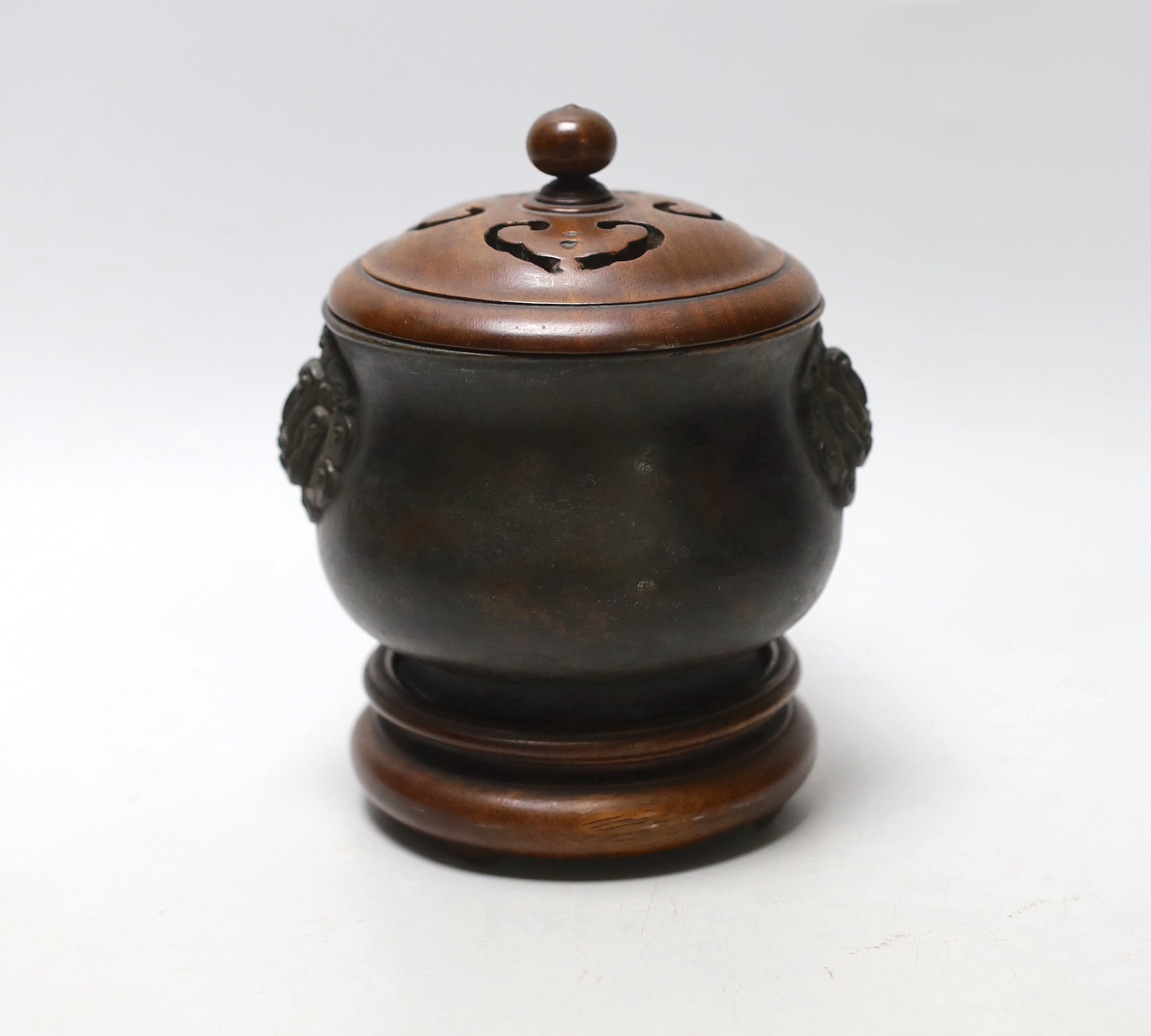 A Chinese bronze censer with carved and pierced wooden lid and stand, 14.5cm                                                                                                                                                