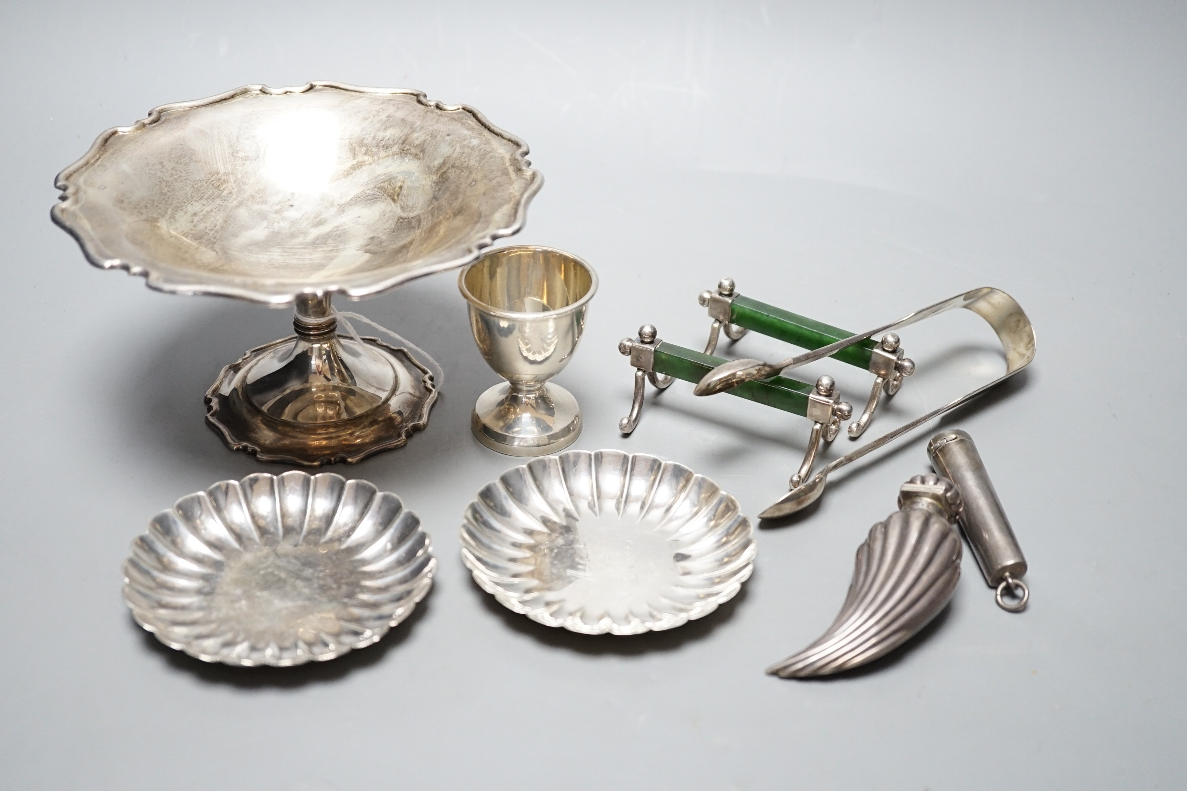 A George V silver tazze, diameter 14.7cm, two small sterling nut dishes, a late Victorian fluted silver scent bottle, of curved form, Horton & Allday, Birmingham, 1889, a pair of silver and nephrite mounted knife rests, 