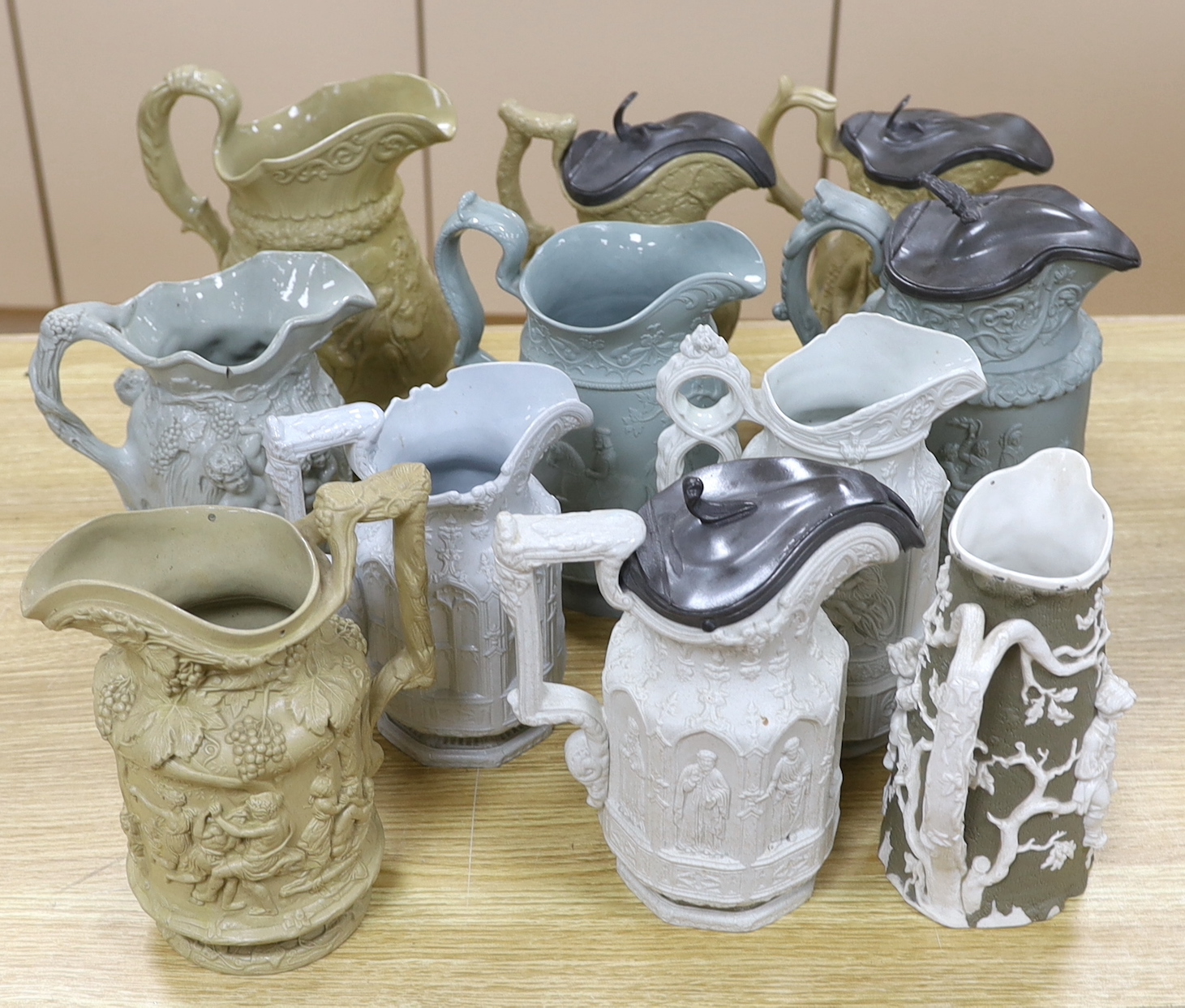 A collection of Victorian Charles Meigh and TJ & JM Mayers stoneware jugs, including Gothic relief designs, some with pewter lids, the largest 23cm high                                                                    