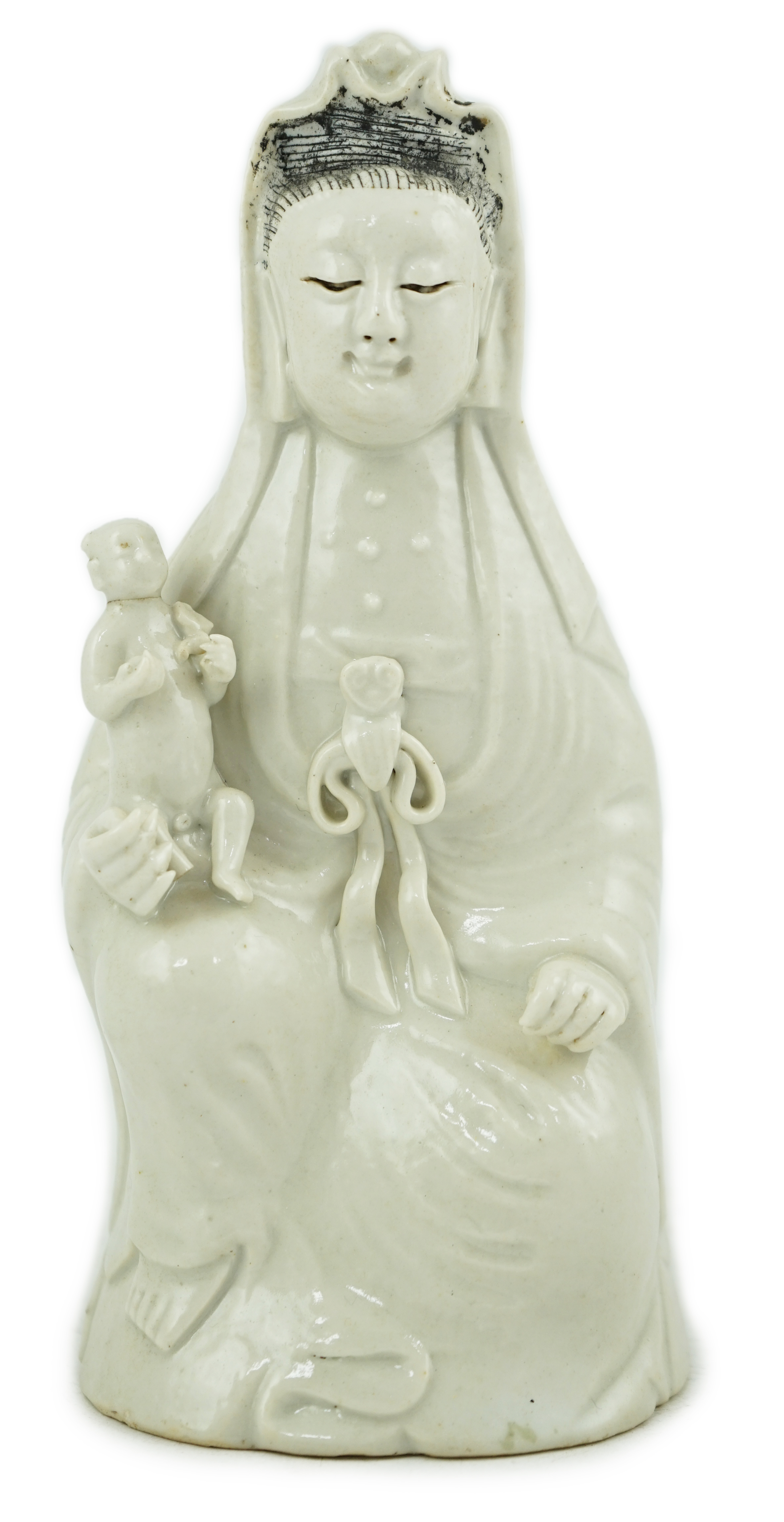 A Chinese white glazed group of Guanyin and child, 18th/19th century                                                                                                                                                        