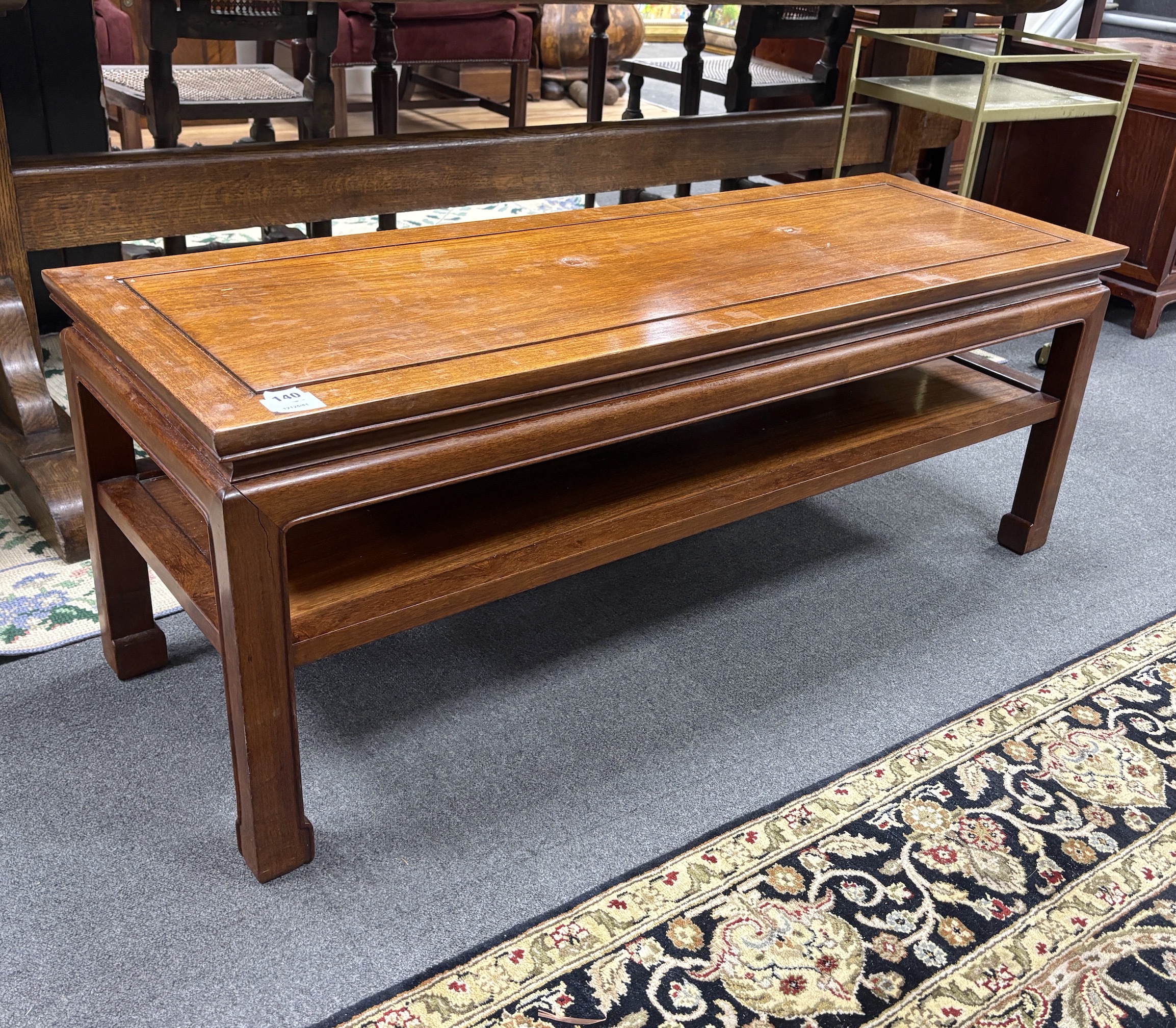 A Chinese rectangular hardwood two tier coffee table, width 122cm, depth 43cm, height 46cm                                                                                                                                  