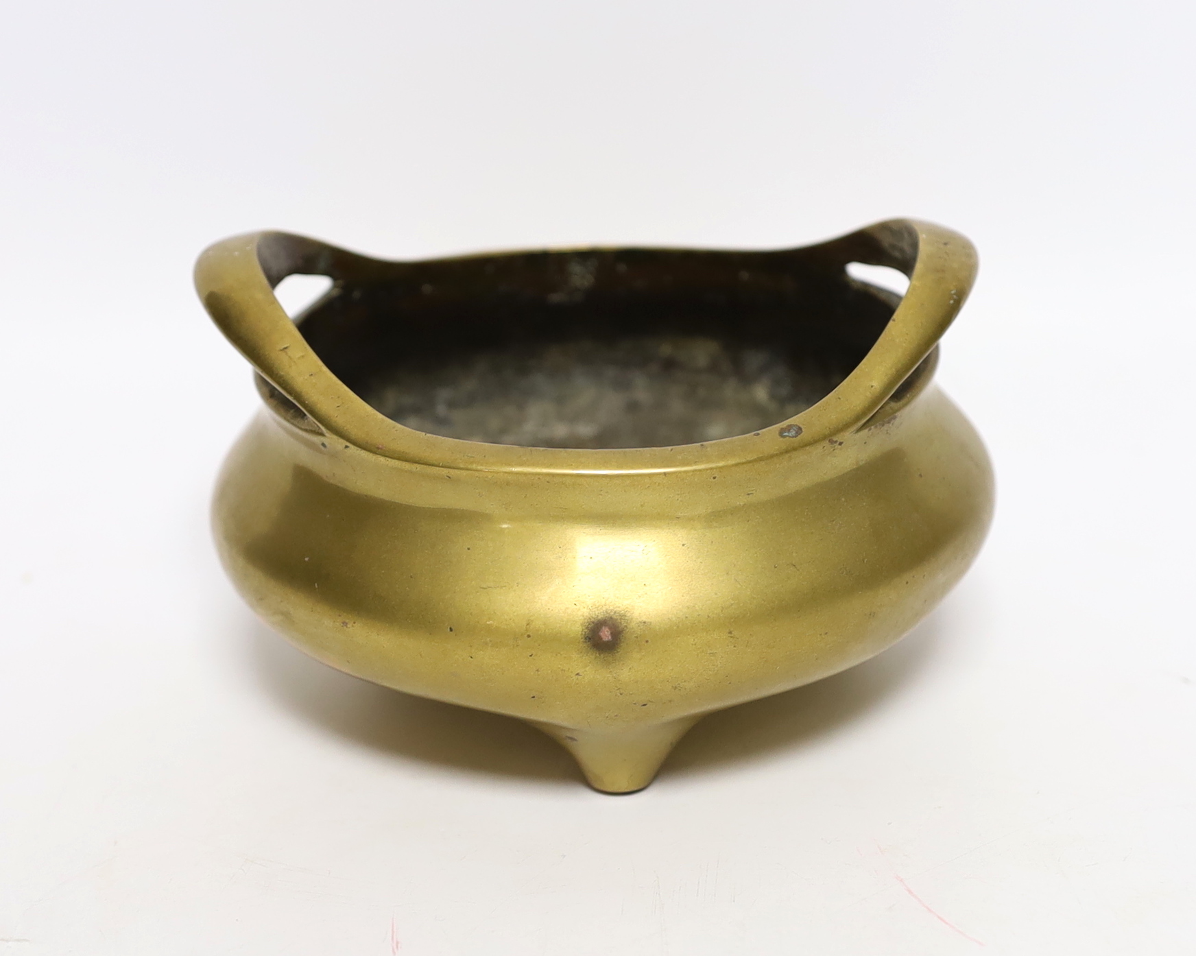 A Chinese bronze tripod censer with twin handles, mark to the base, 14cm wide                                                                                                                                               