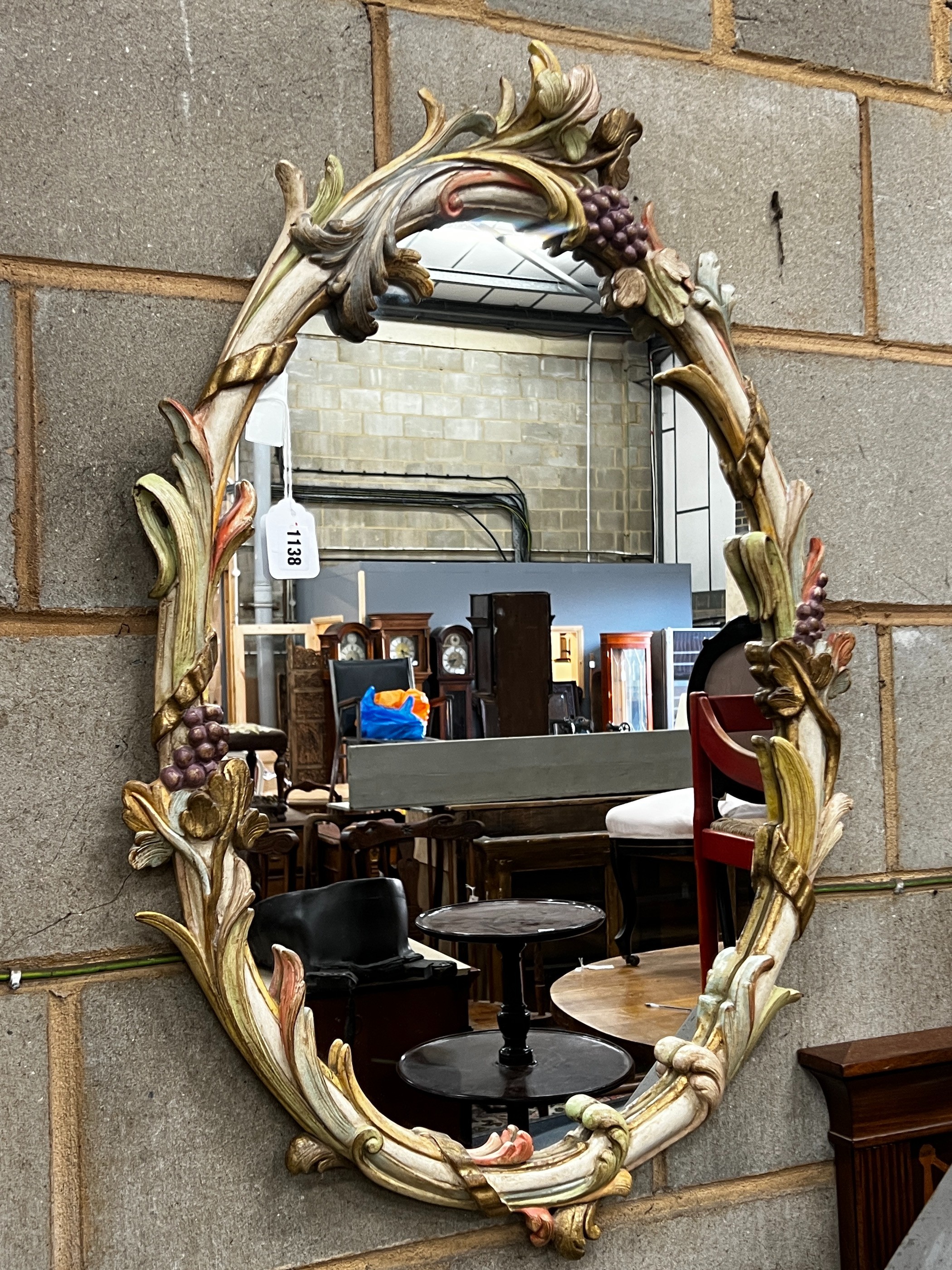 An oval painted frame wall mirror, width 58cm, height 90cm                                                                                                                                                                  