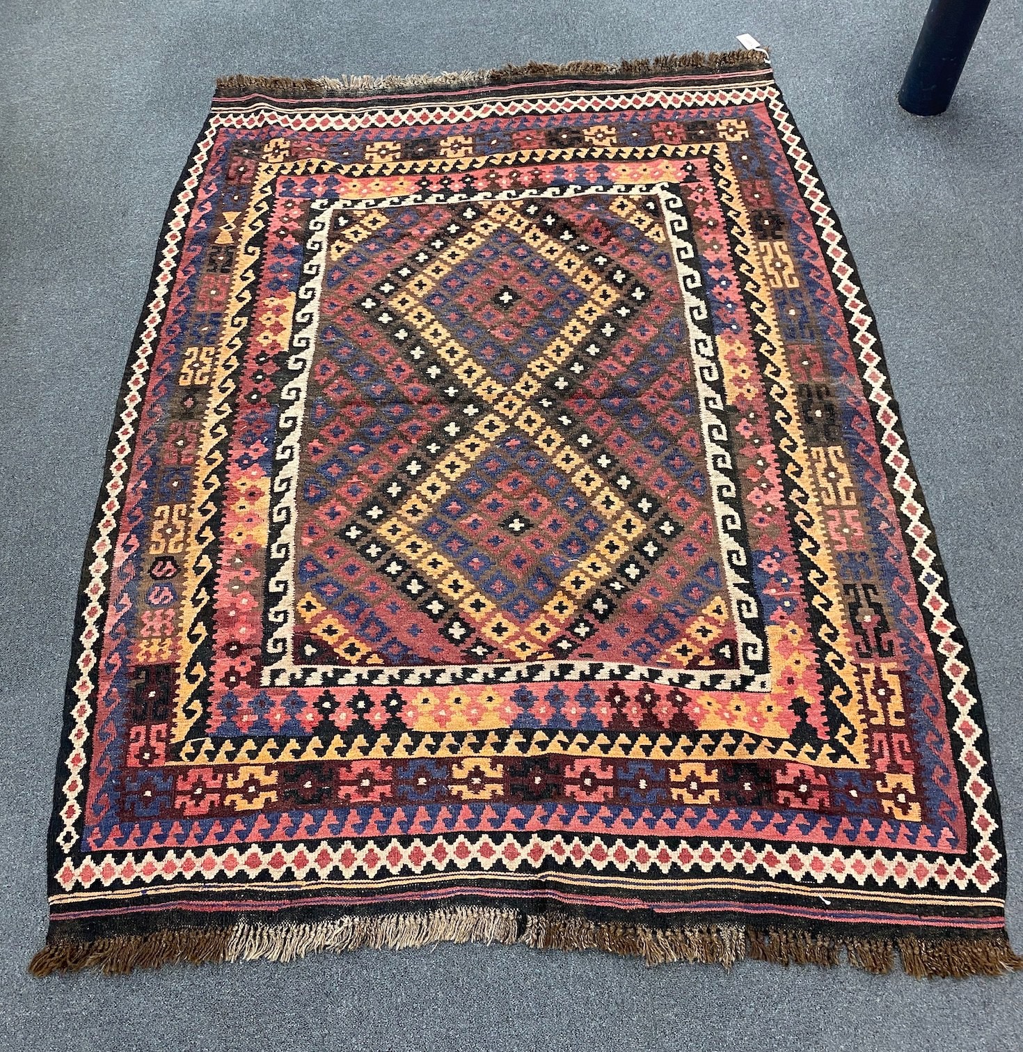 A polychrome flatweave rug, 203 x 160cm                                                                                                                                                                                     