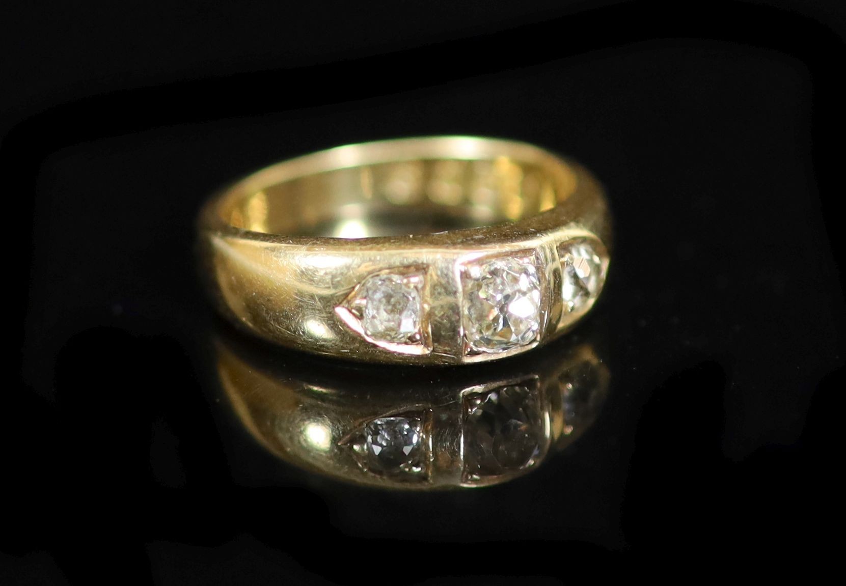 A George V 18ct gold and three stone diamond ring                                                                                                                                                                           