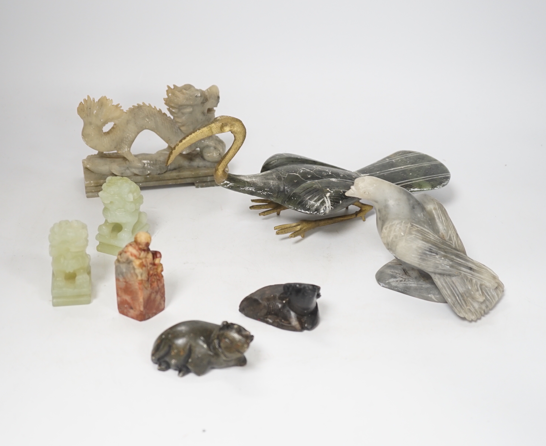 A group of Chinese soapstone and bowenite animal figures and a figural seal, largest 25cm wide (8)                                                                                                                          