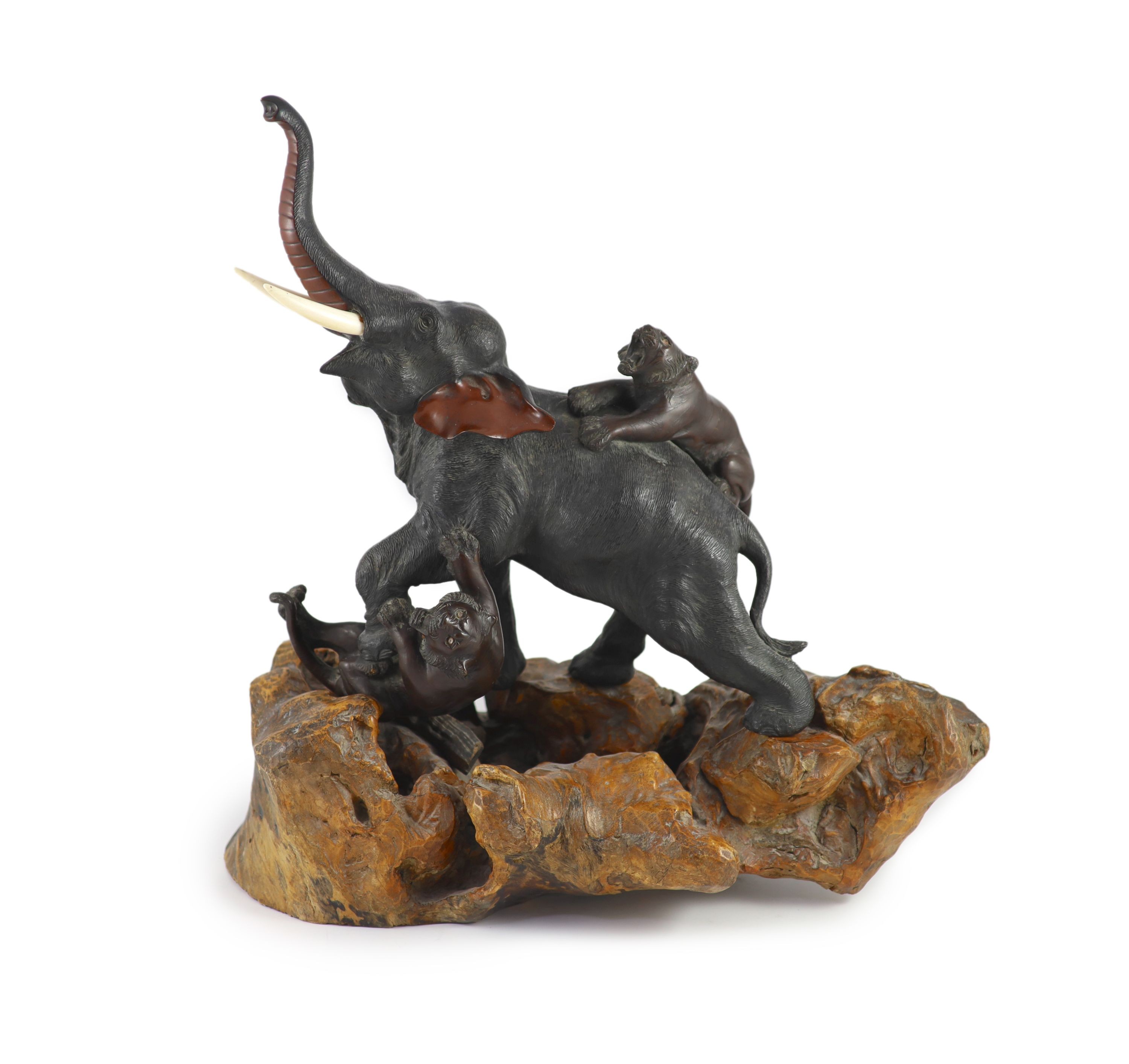 A good Japanese bronze elephant and tiger group, Meiji period signed Seiya saku, Total height 55cm and length 55cm including stand                                                                                          