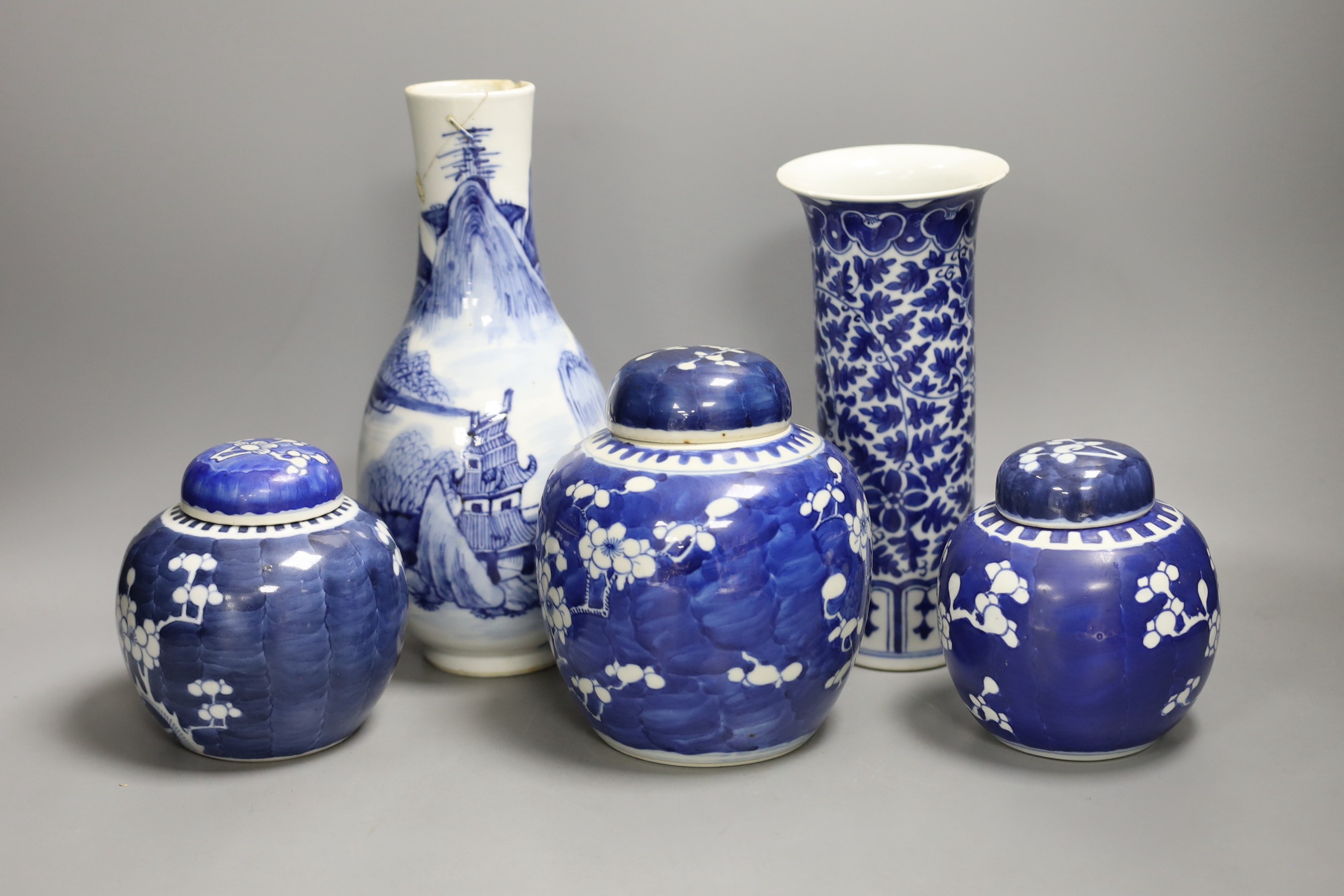 A 19th century Chinese blue and white ‘landscape’ vase, an early 20th century blue and white sleeve vase and three blue and white jars and covers. Tallest 25.5cm                                                           