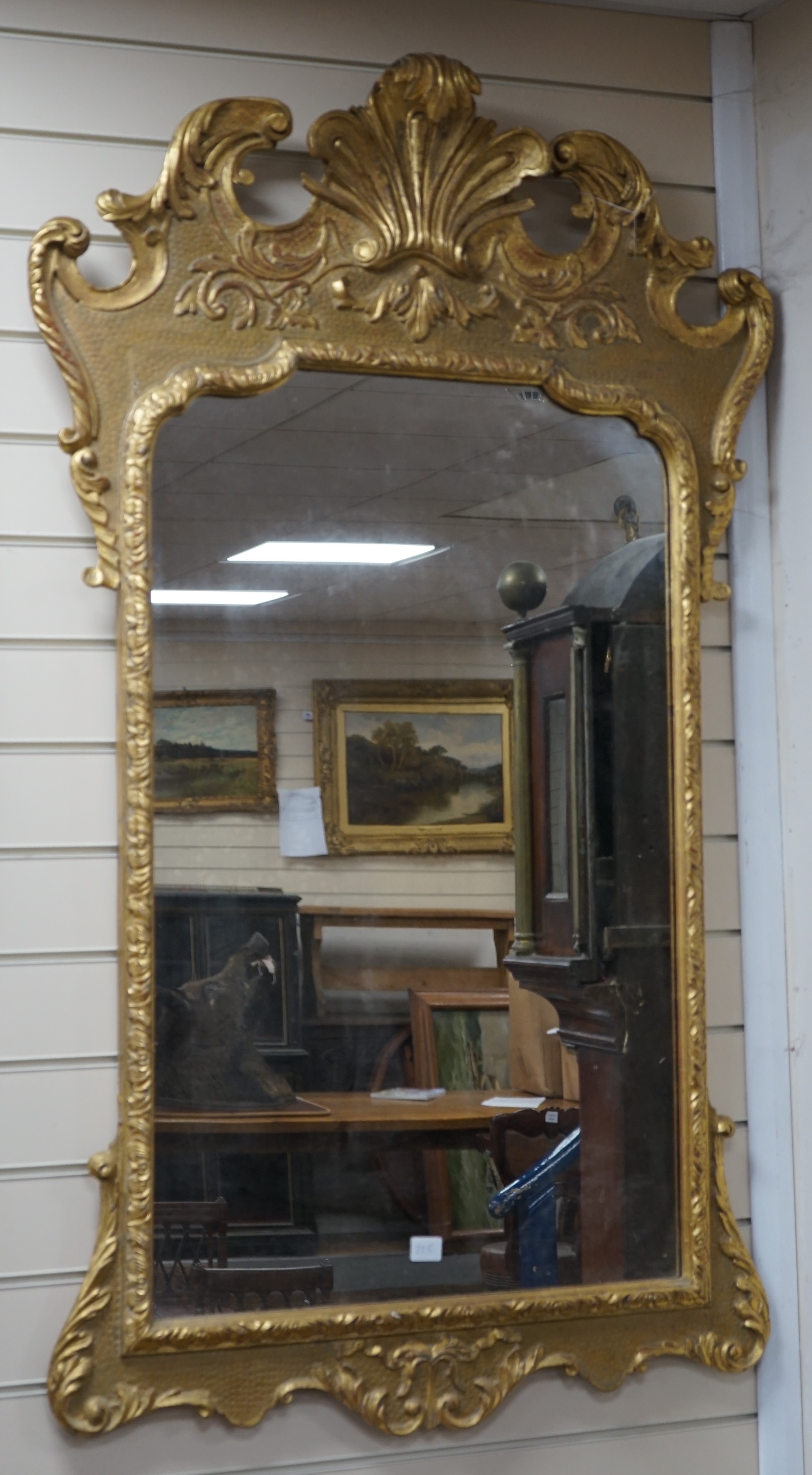 A George II style carved giltwood and composition wall mirror, width 76cm, height 135cm                                                                                                                                     