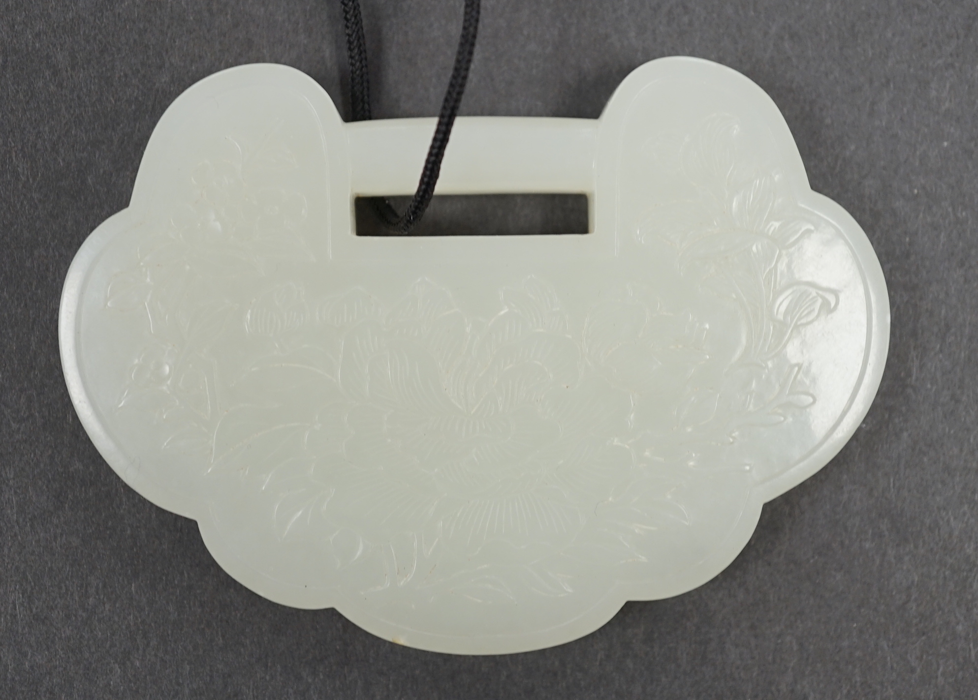 A Chinese pale celadon jade lock pendant, 19th/20th century, 8cm                                                                                                                                                            