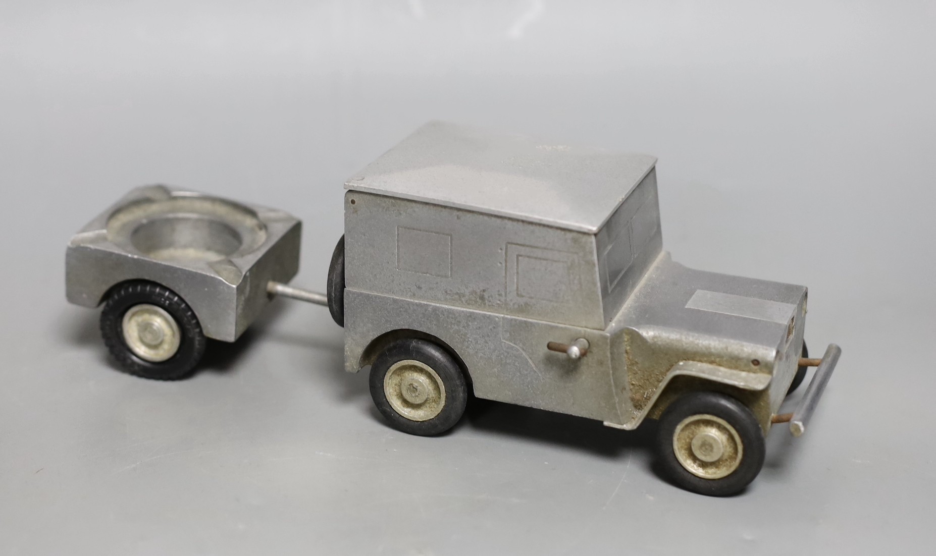 A German cast metal ‘Willy's Jeep’ cigarette case, ash tray and lighter novelty, early post war, 23cms wide                                                                                                                 