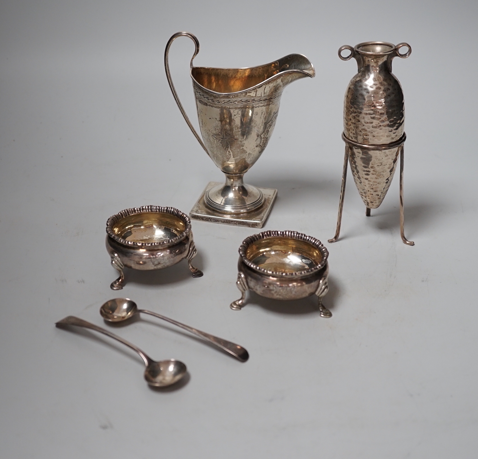 A pair of George III silver salts, London, 1778 and two later spoons, an Edwardian silver cream jug and a 925 specimen vase on stand.                                                                                       