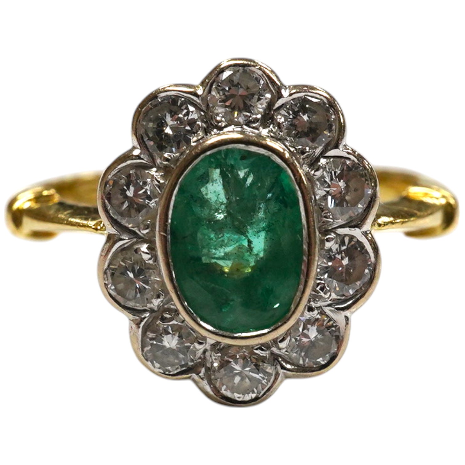 A modern 18ct gold, emerald and diamond set oval cluster ring, size L, gross weight 3.5 grams. Condition - poor to fair                                                                                                     