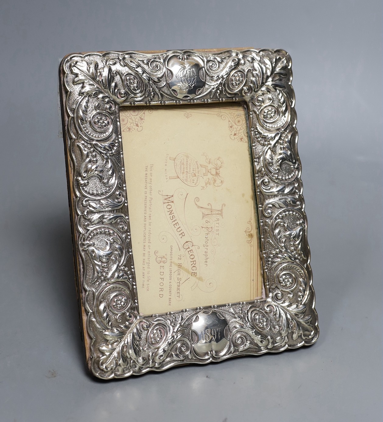 A late Victorian repousse silver mounted rectangular photograph frame, John Newton Mappin, London, 1896, 19.3cm.                                                                                                            