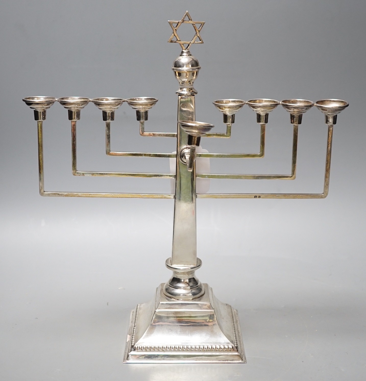 A George VI silver Hanukkah menorah, by A. Taite & Sons Ltd, London, 1948, height 30.5cm, 16.8oz.                                                                                                                           