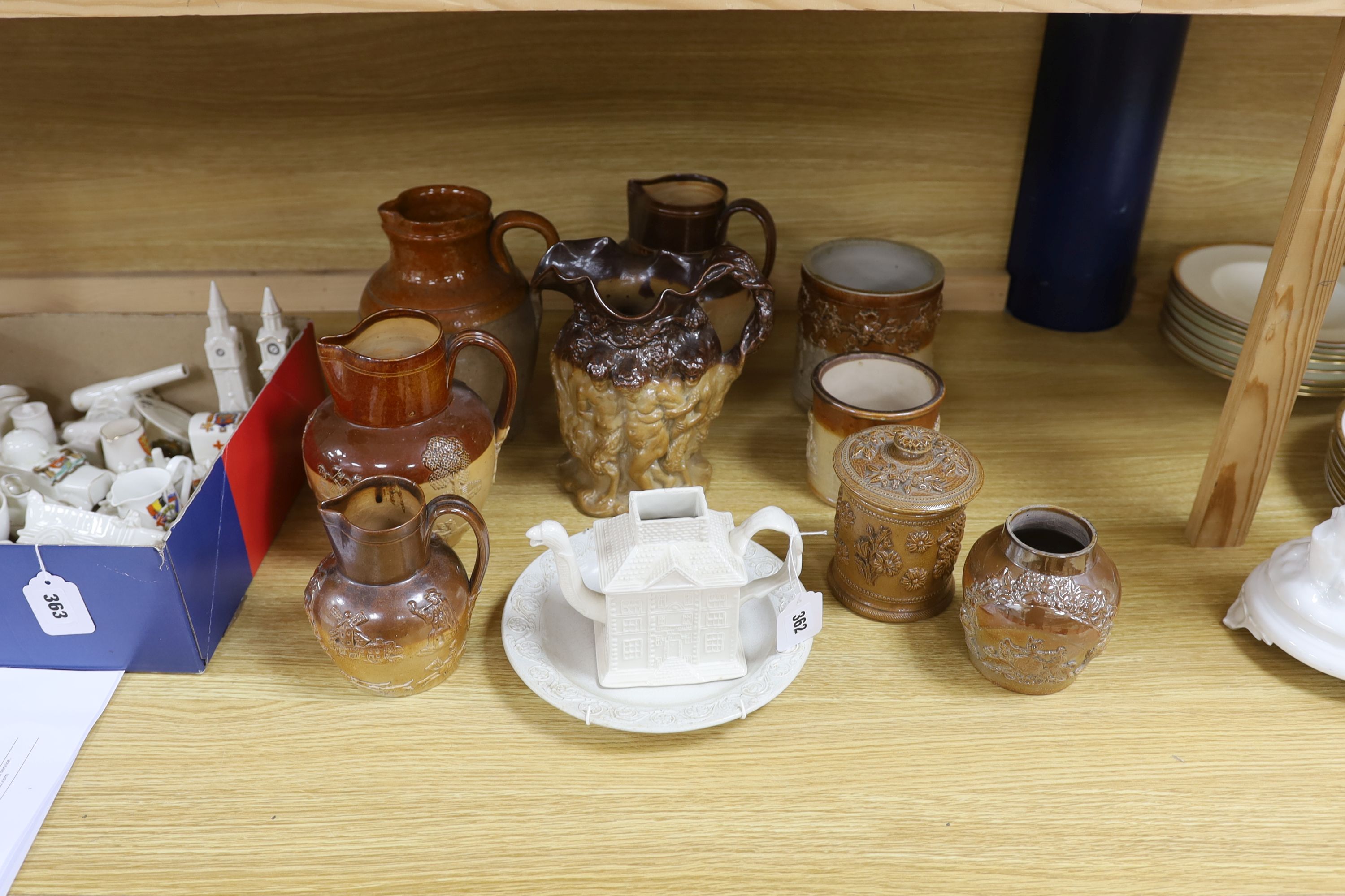 A Victorian stoneware jug, the sides moulded with bacchanalians, together with other earthenware jugs, a white salt glazed dish and 'house' teapot, the latter lacking lid, the largest 23cm high                           