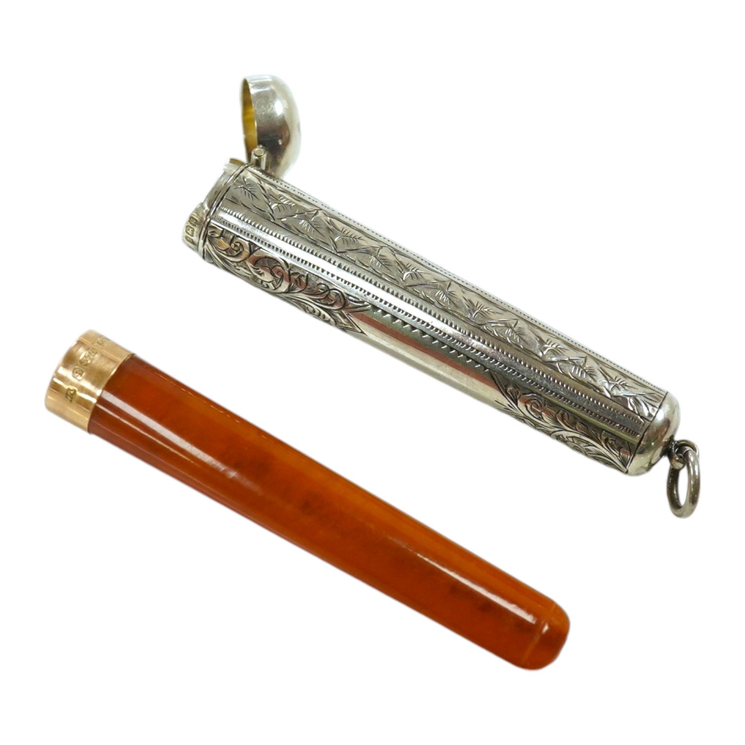 A 9ct gold mounted amber cigarette holder, 78mm, in a silver case. Condition - fair                                                                                                                                         