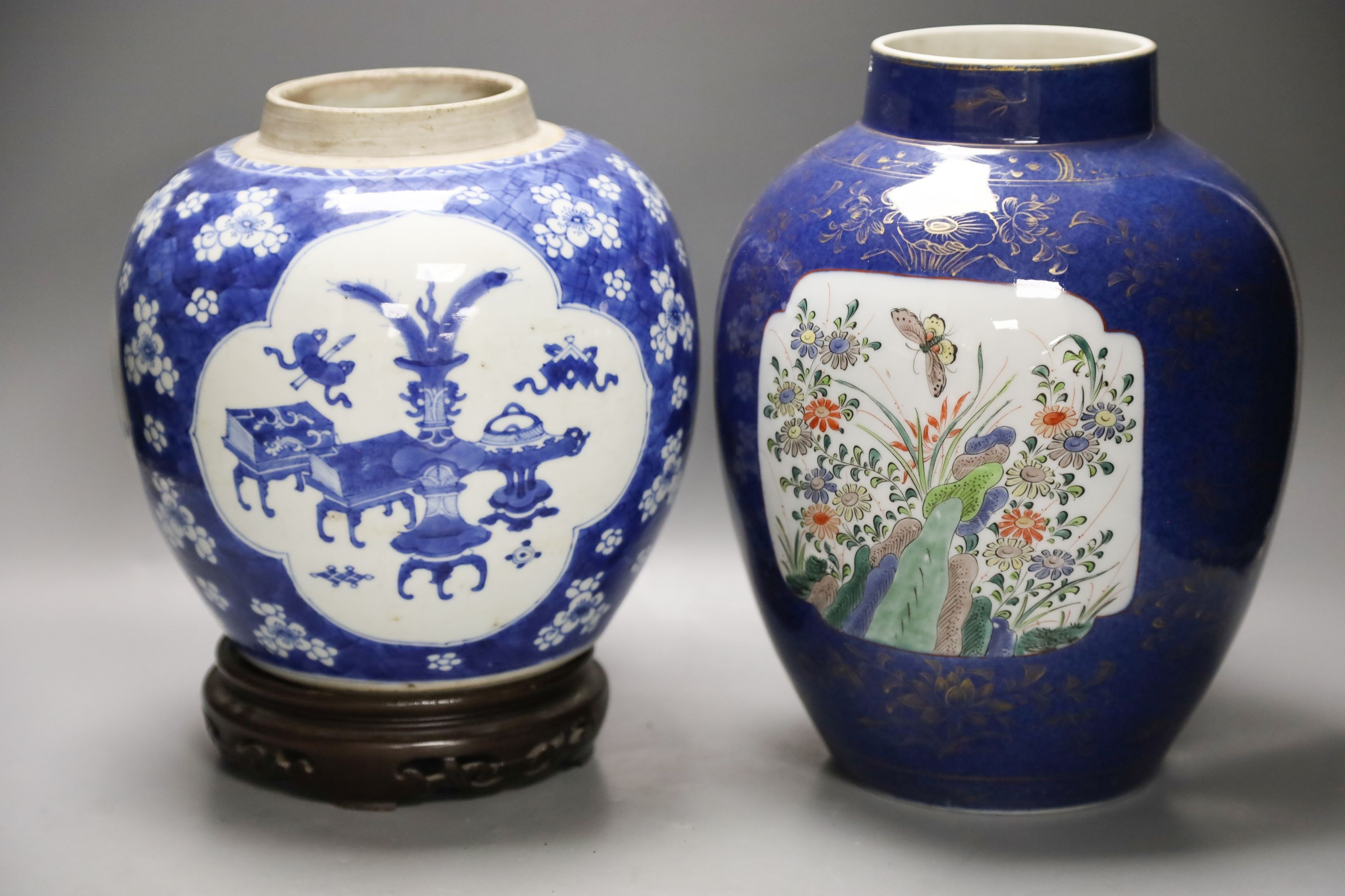 A Chinese Kangxi blue and white hundred antiques jar, 21cm, cracked, with hardwood stand and a Samson powder blue jar, 26cm, wear                                                                                           