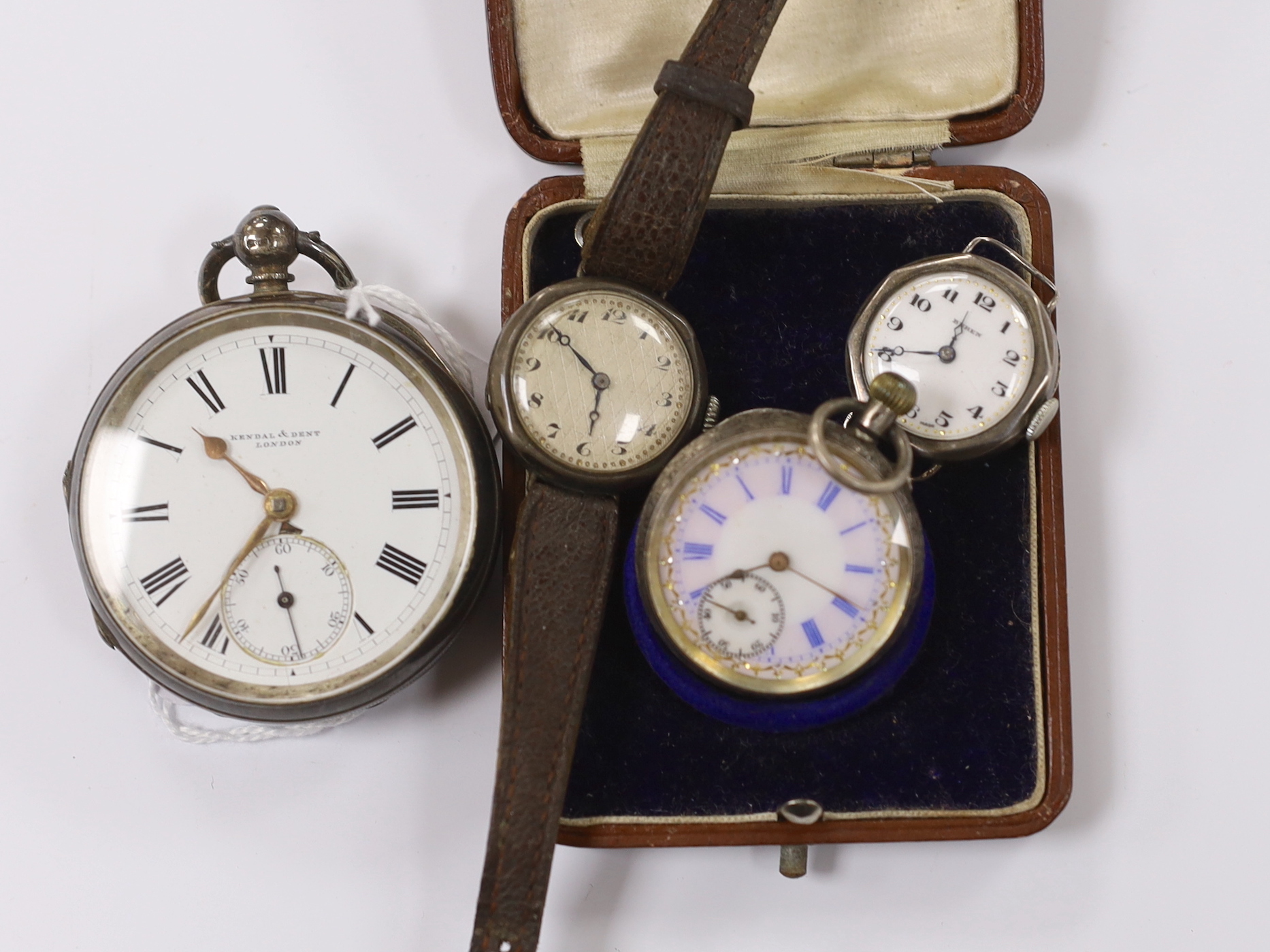 A late Victorian silver open face pocket watch, retailed by Kendall & Dent, a cased Swiss 935 standard white metal fob watch and two silver manual wind wrist watches.                                                      